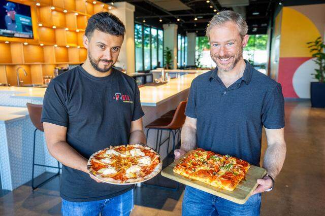 Executive Chef Juan Ramazzini, left, holds a Parma pizza while owner Aaron Parker holds a Sicilian-style Catania pizza inside of La Porta Restaurant & Bar in Arden Arcade on April 16, 2024.