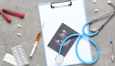 Sonogram image with medical supplies on grunge background. IVF concept