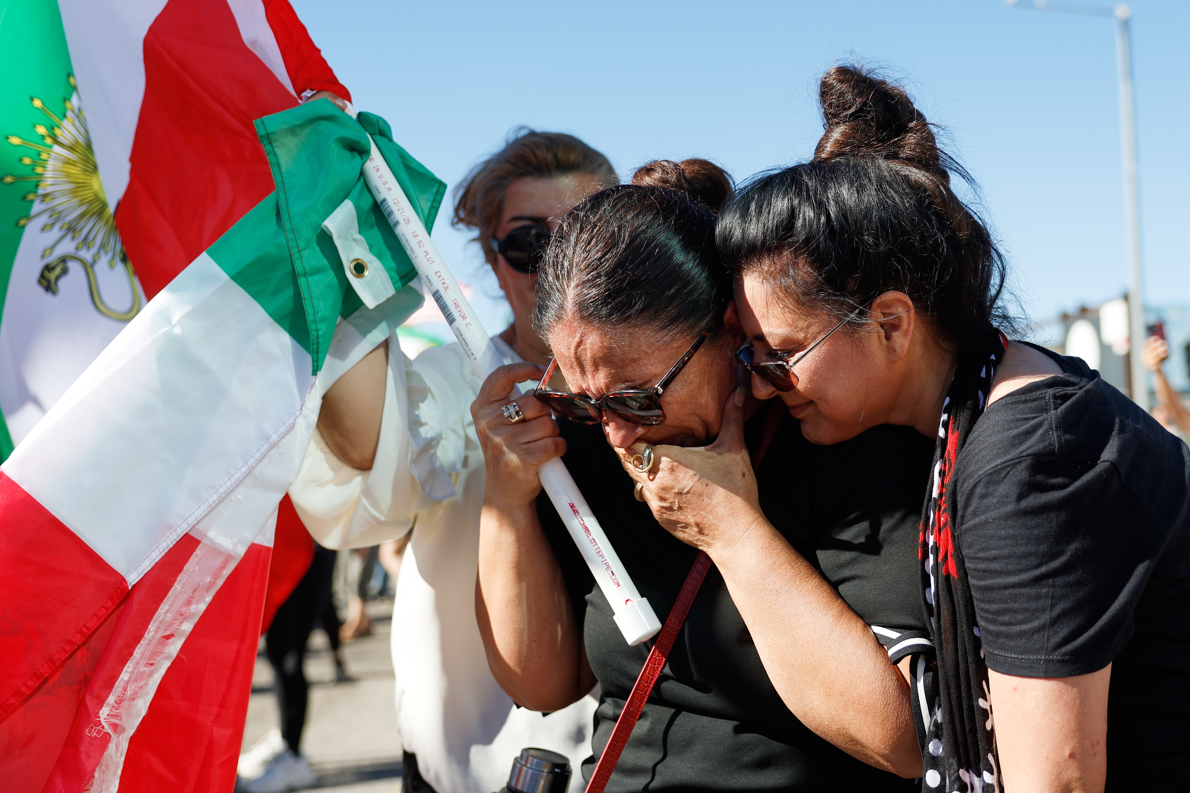Two women embrace during a demonstration in reaction to the...