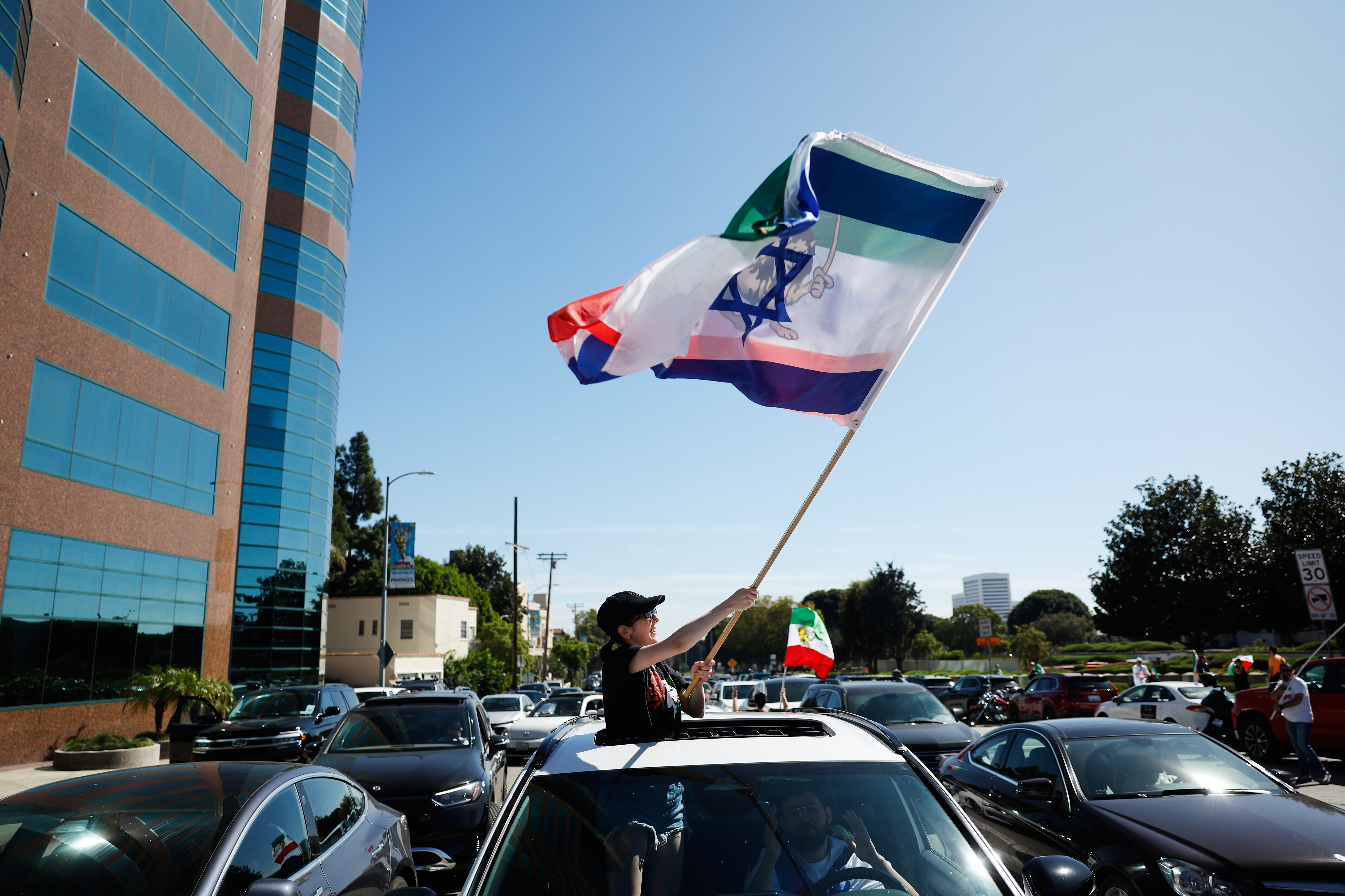 Flags are waved during a demonstration in reaction to the...