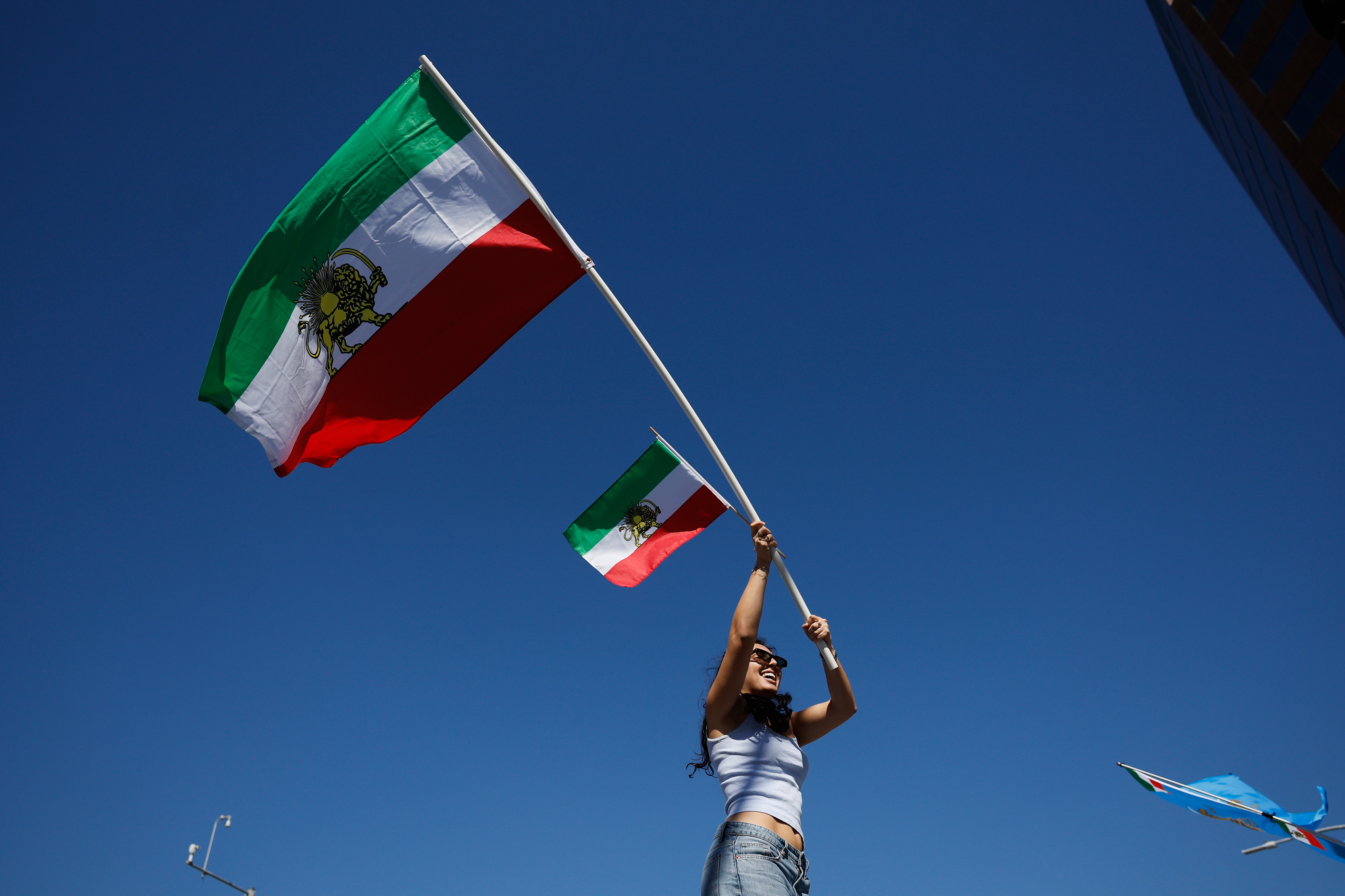A demonstrator waves Iranian flags in reaction to the U.S....