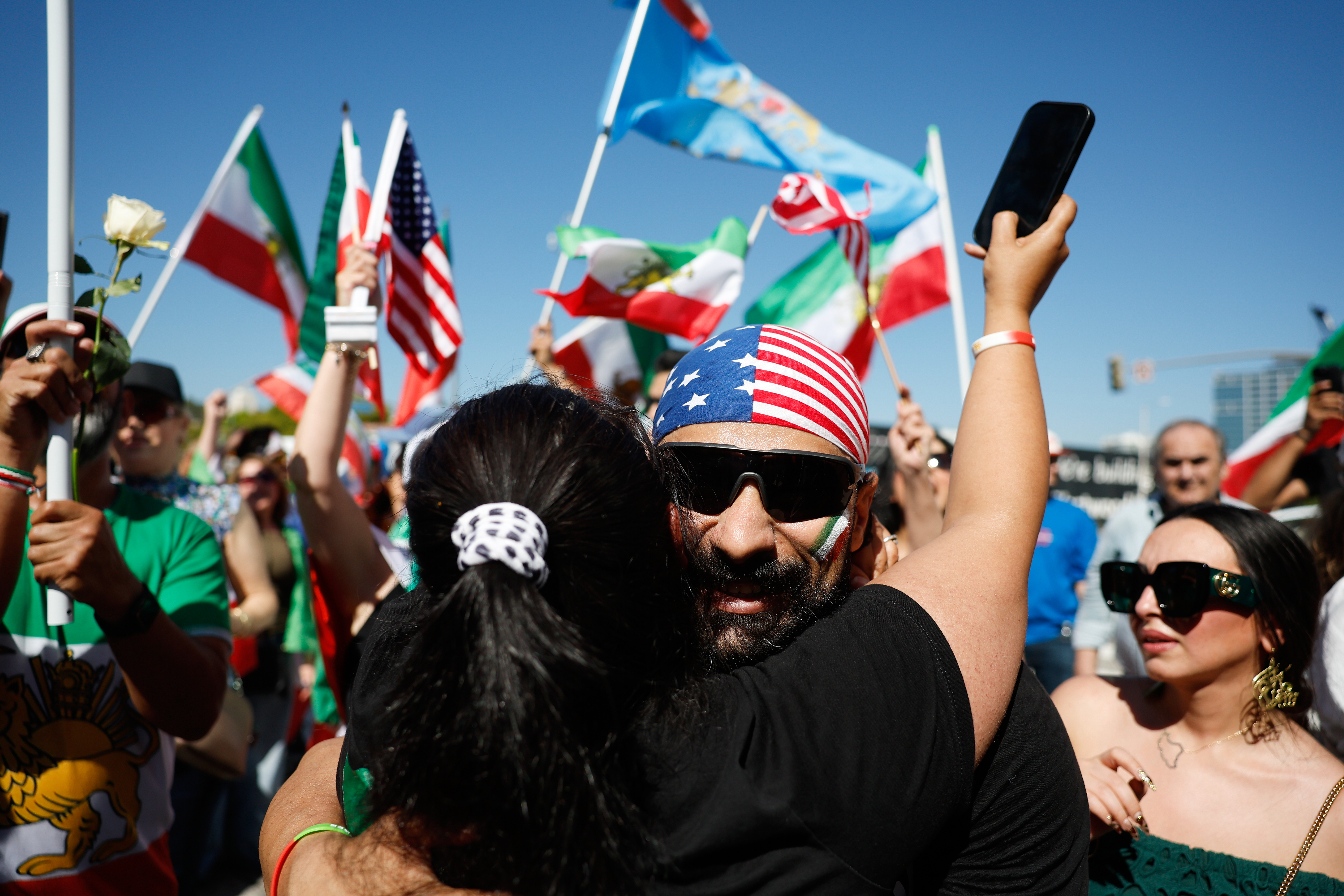 Demonstrators hug as they march in reaction to the U.S....