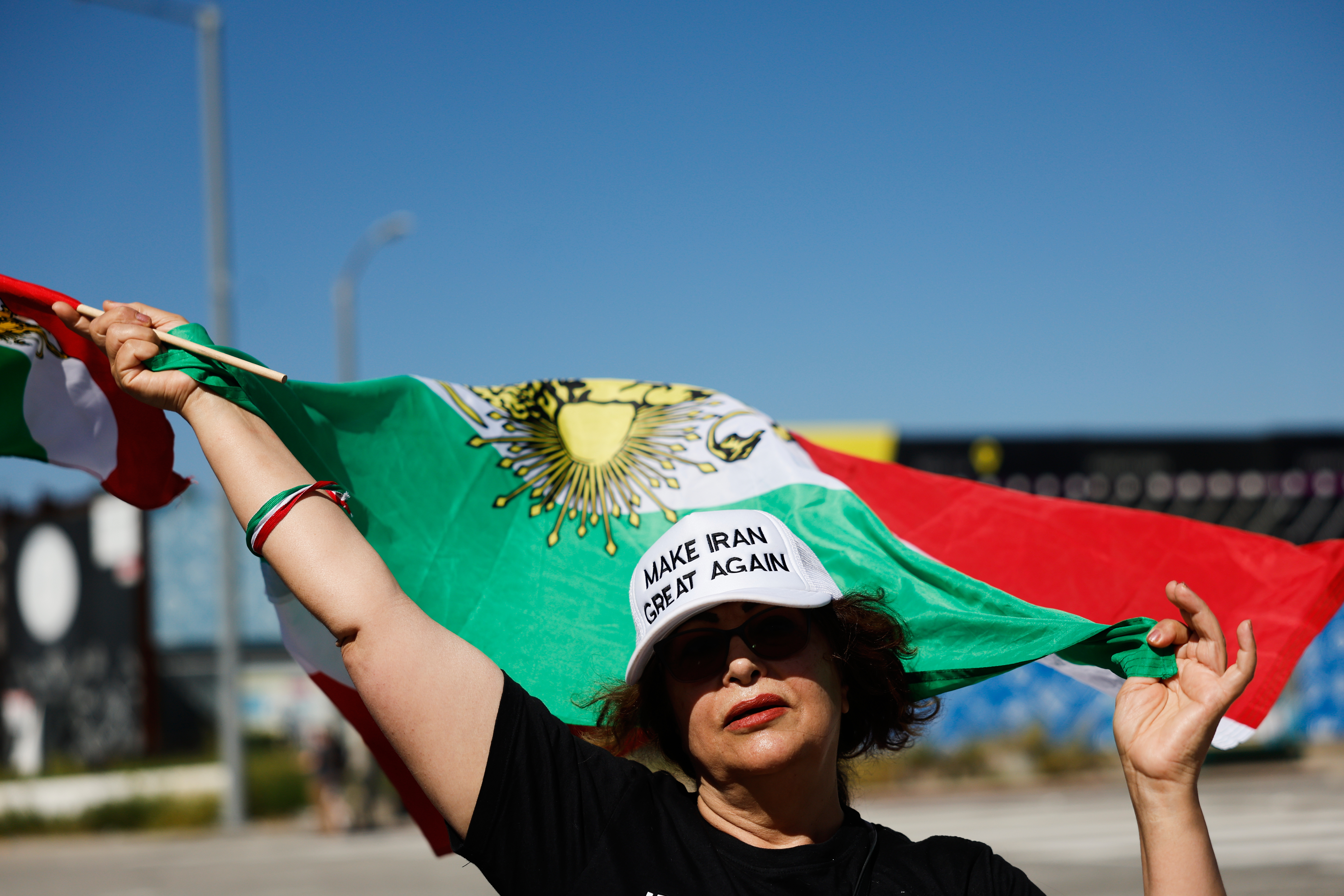 An Iranian flag is waved during a demonstration in reaction...