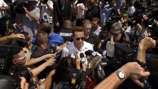 Arnold Schwarzenegger is swarmed by the media during the opening ceremonies of the Inner-City games on Friday, August 8, 2003, a day after he took out papers to run for California governor in the recall election.