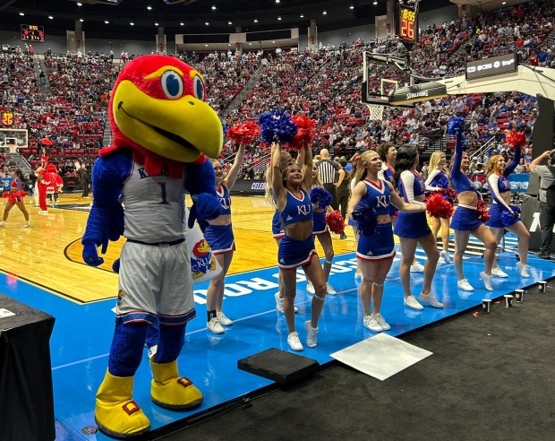 The Kansas mascot joins the Jayhawks cheerleaders courtside during the game against St. John's. (Kirk Kenney / San Diego Union-Tribune)
