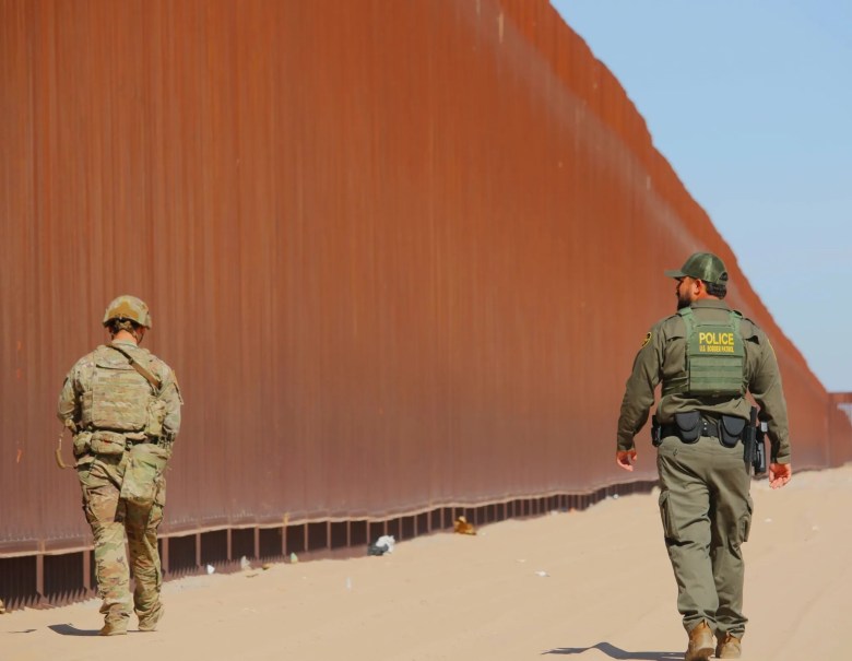 A soldier from the 759th Military Police Battalion, 89th Military Police Brigade, accompanies a U.S. Border Patrol agent on patrol near the wall in Yuma, Arizona, in June.