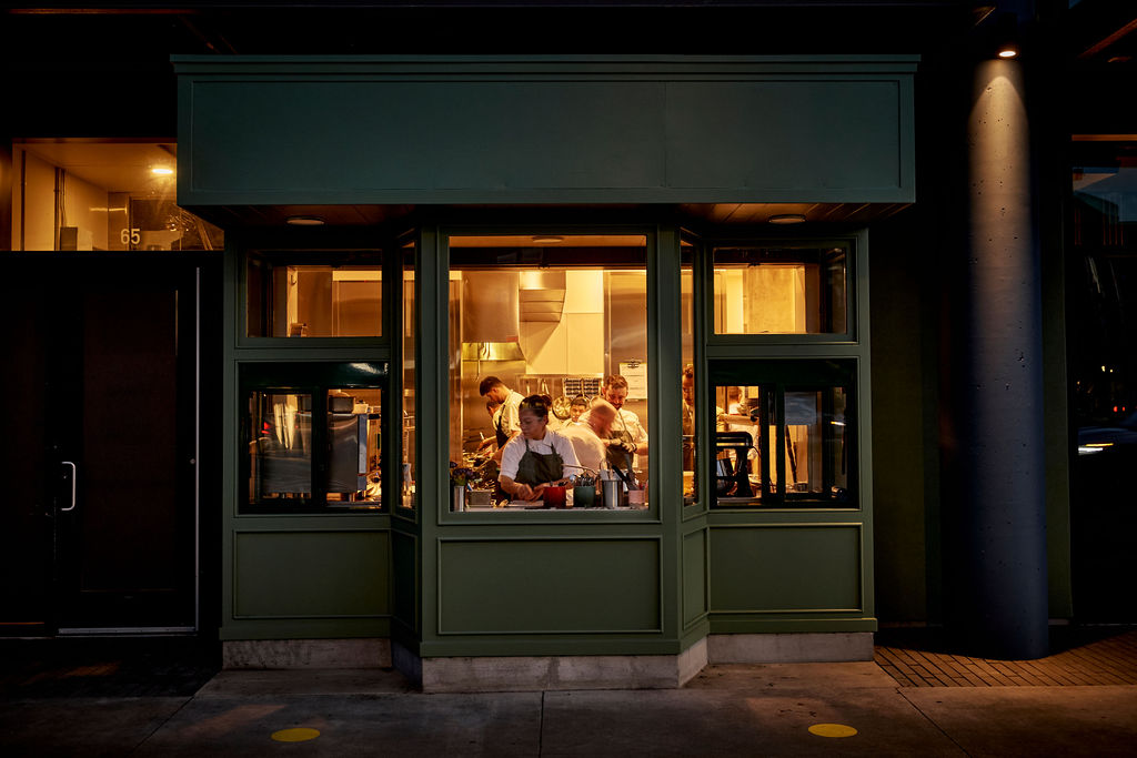 A pastry window gives a view into the JouJou kitchen from the street.