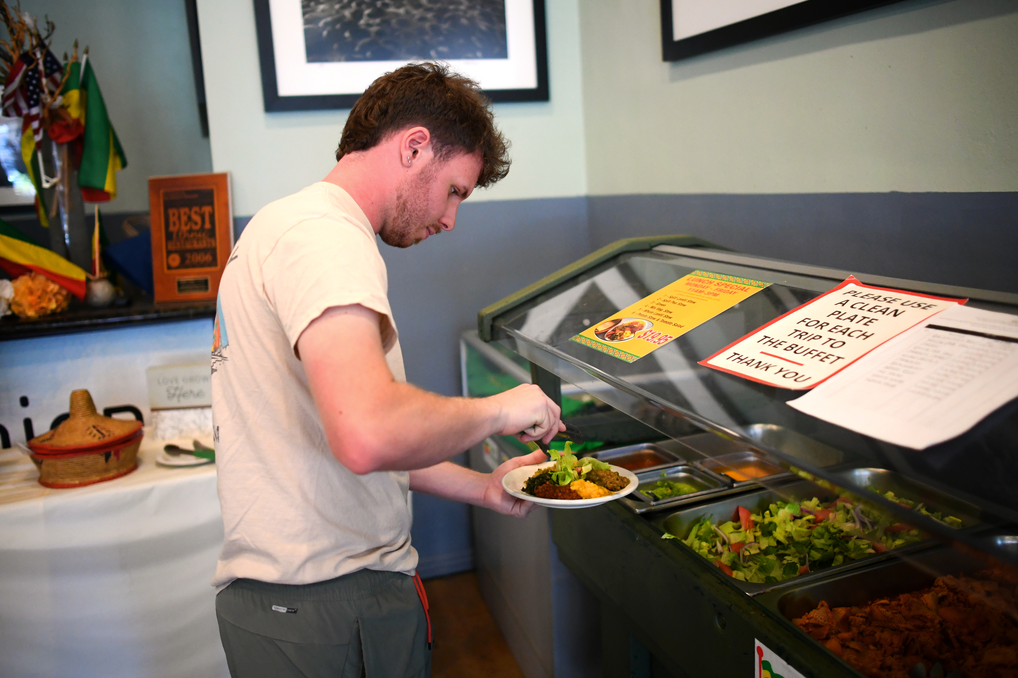 Mason Melito fills a plate at the vegan buffet at...