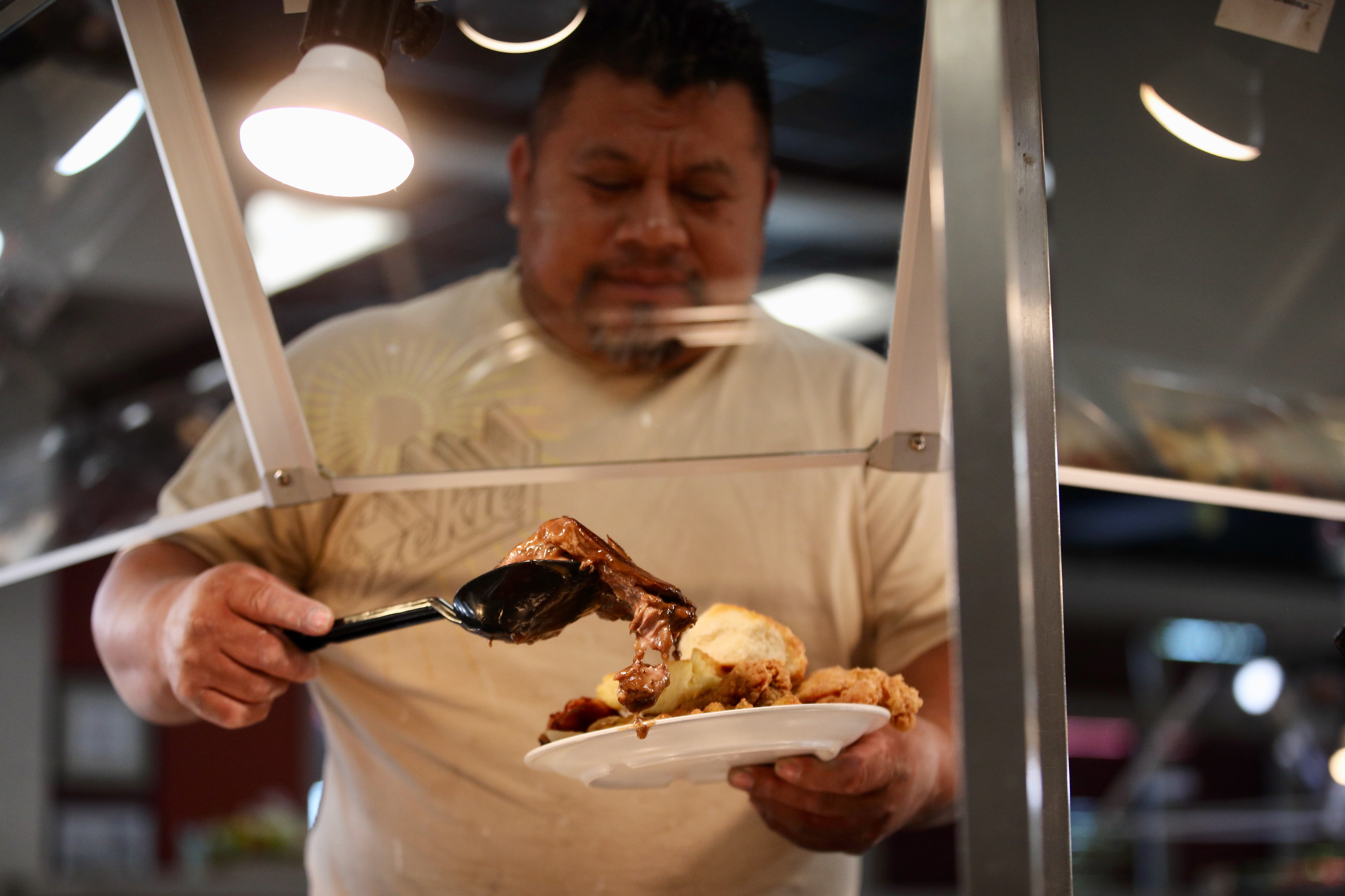 Andres Argueta of Rowland Heights loads his plate during lunch...