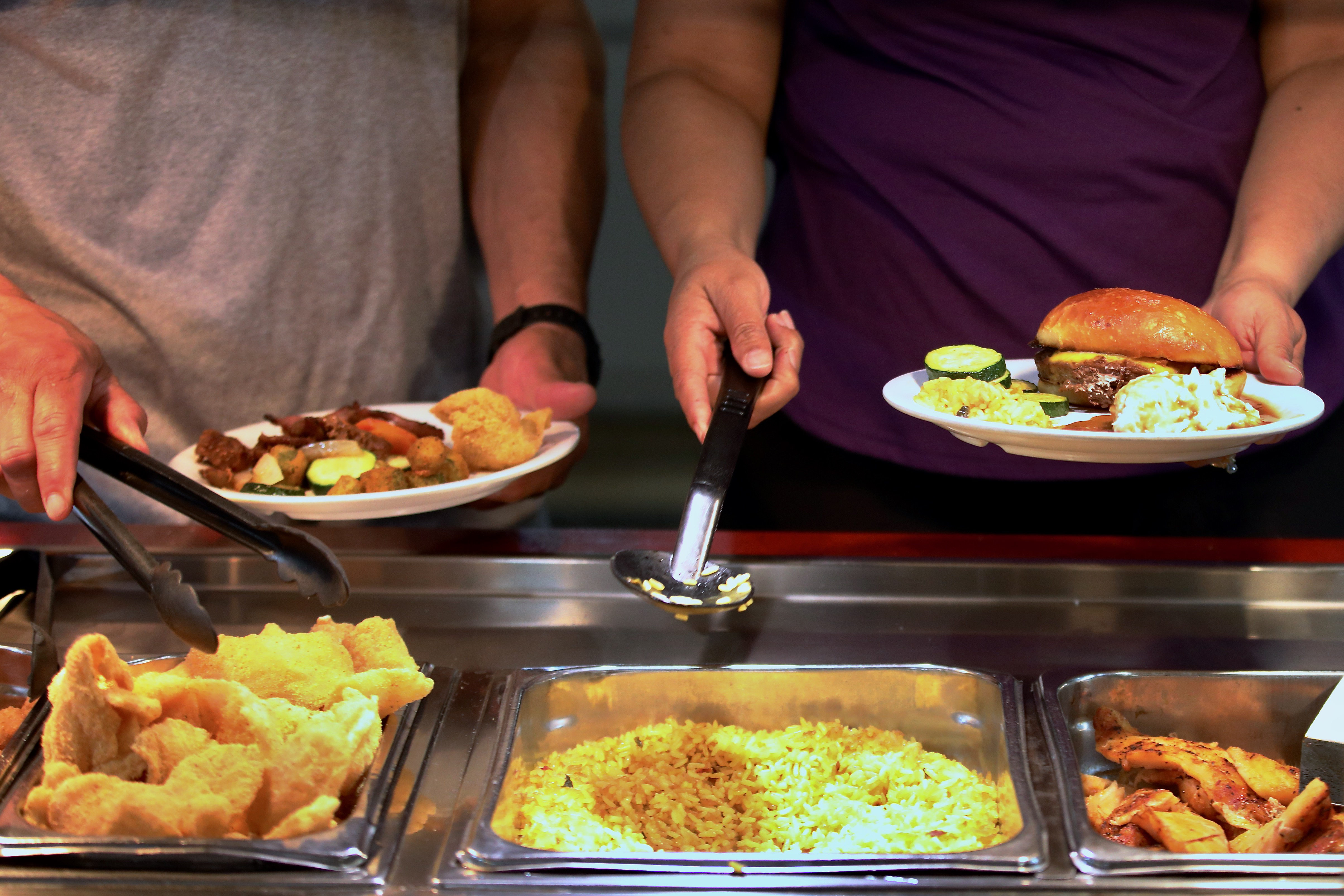 Patrons visit the buffet during lunch hour at Golden Corralâs...
