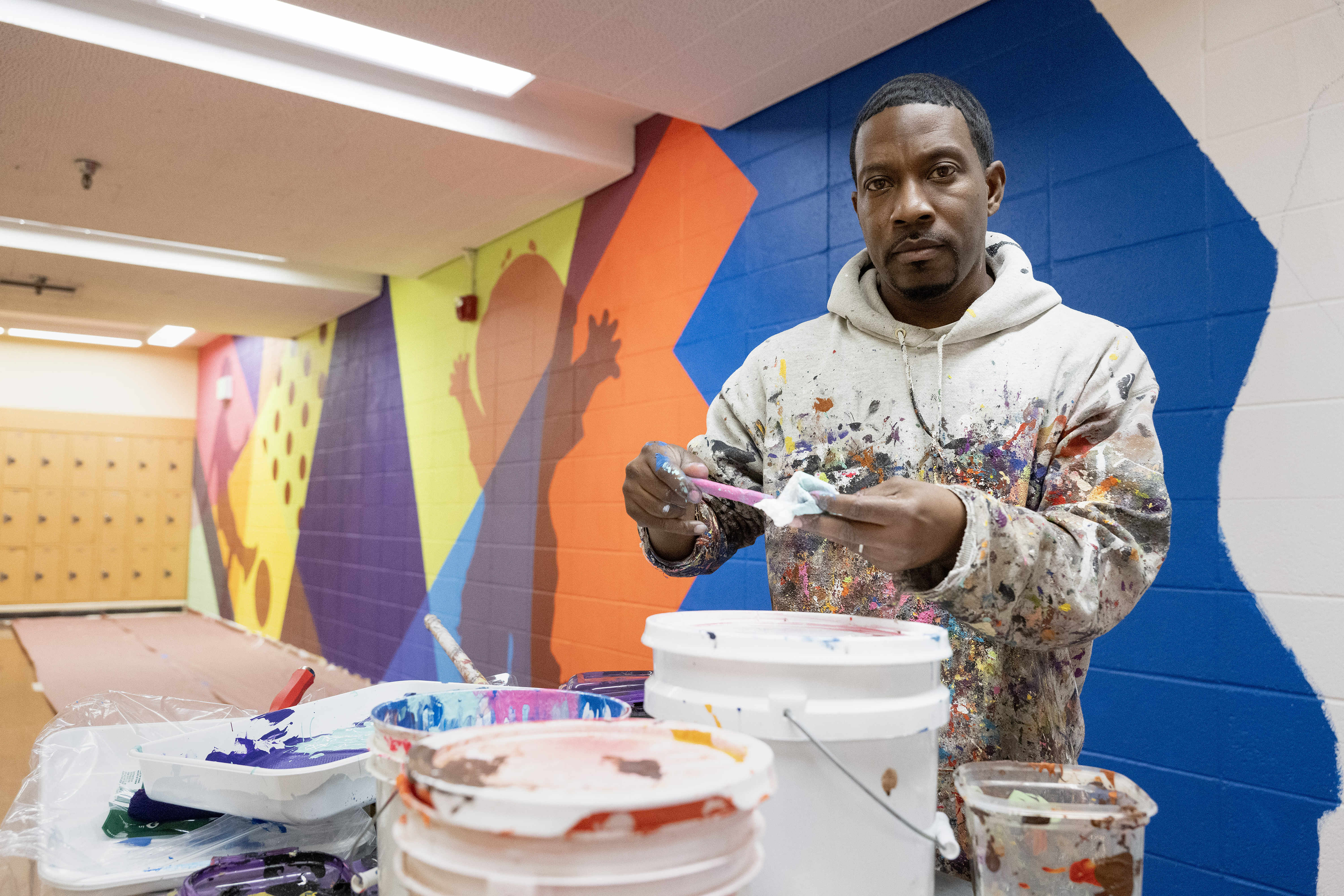 Muralist Mike Norice poses for a portrait at Audubon Middle...