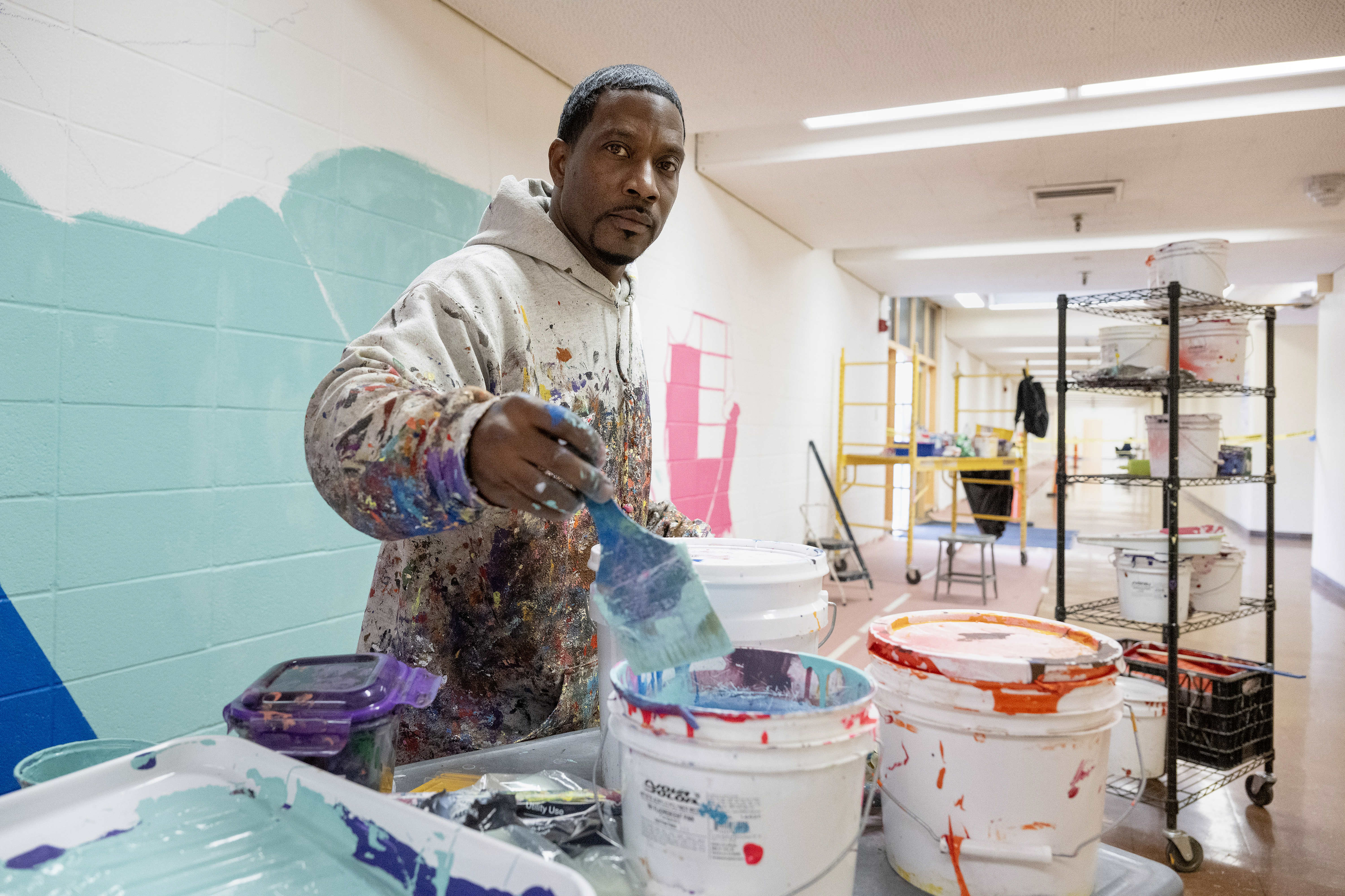 Muralist Mike Norice poses for a portrait at Audubon Middle...