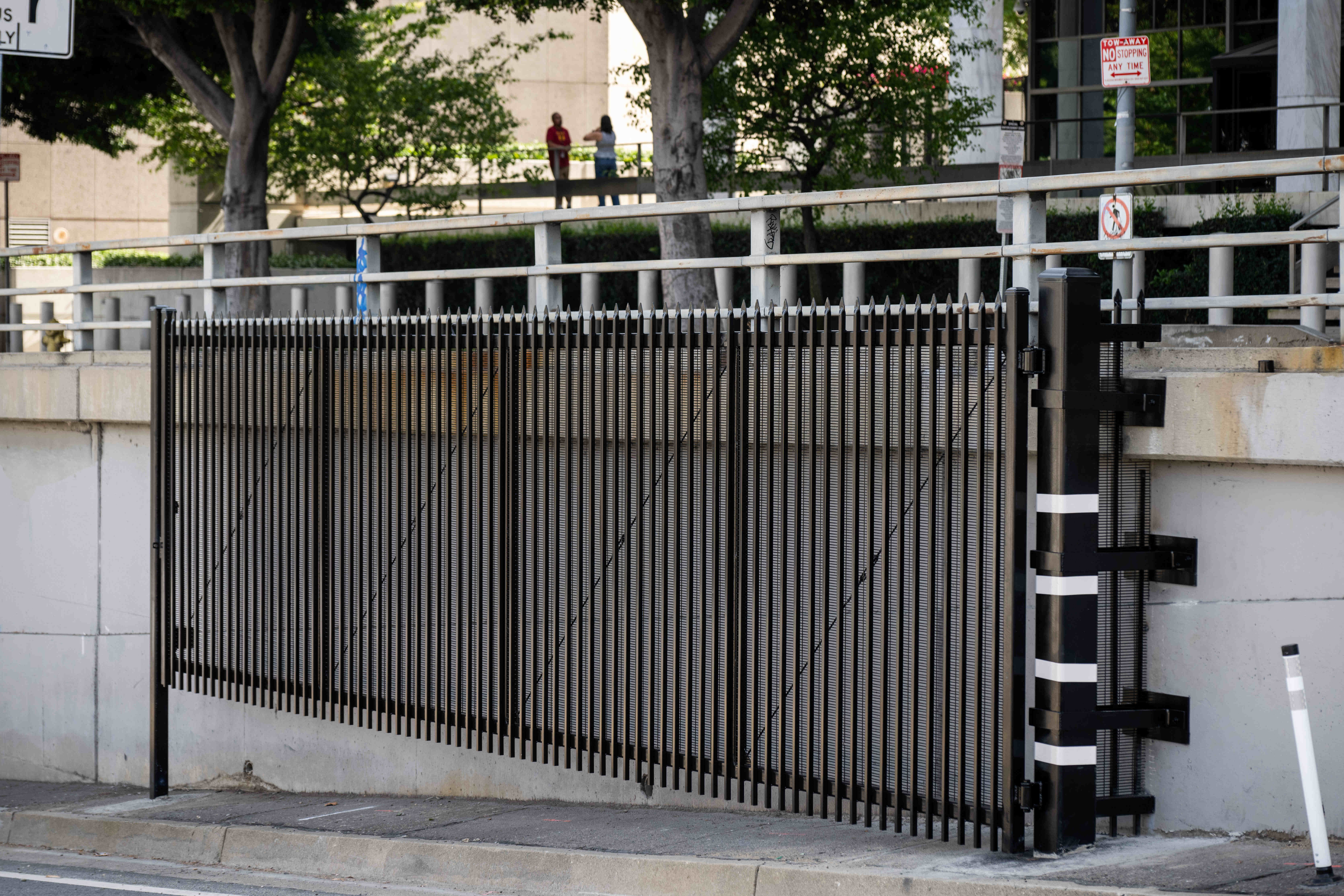 A swinging gate sits along the southbound Los Angeles Street...