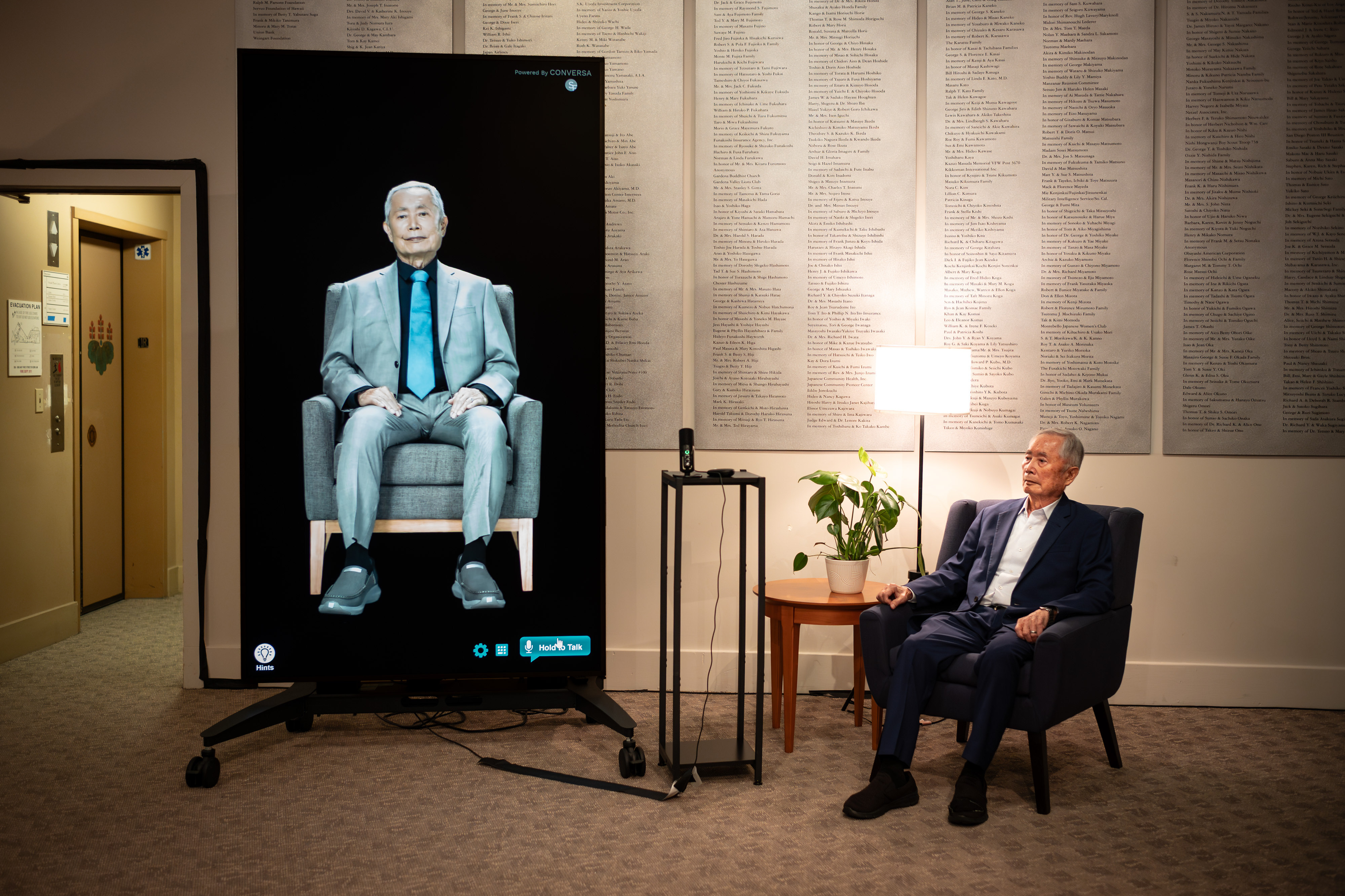 Actor George Takei sits with an AI image of himself...