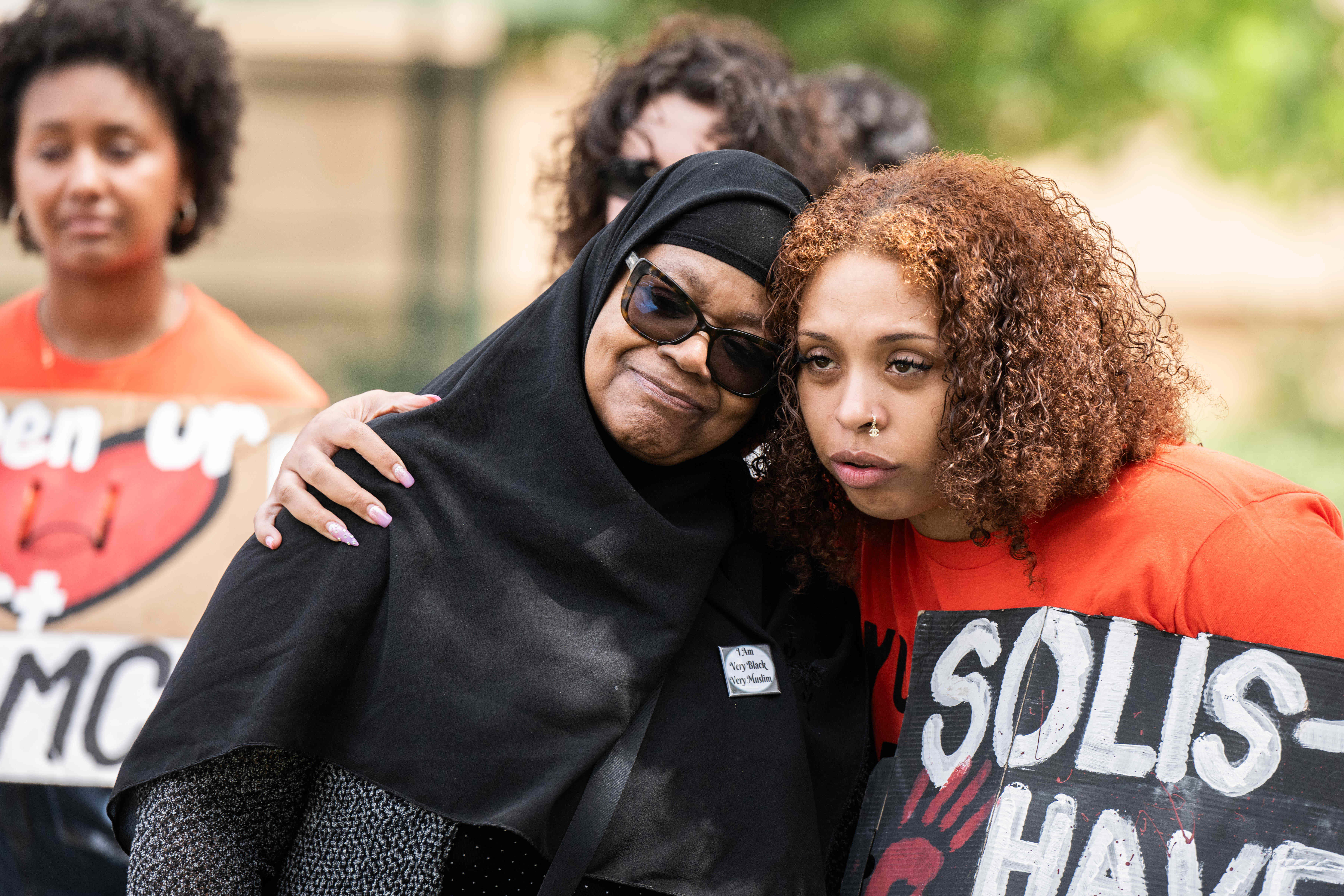 Khadijah Shabazz, left, is hugged by Saharra White, of Dignity...