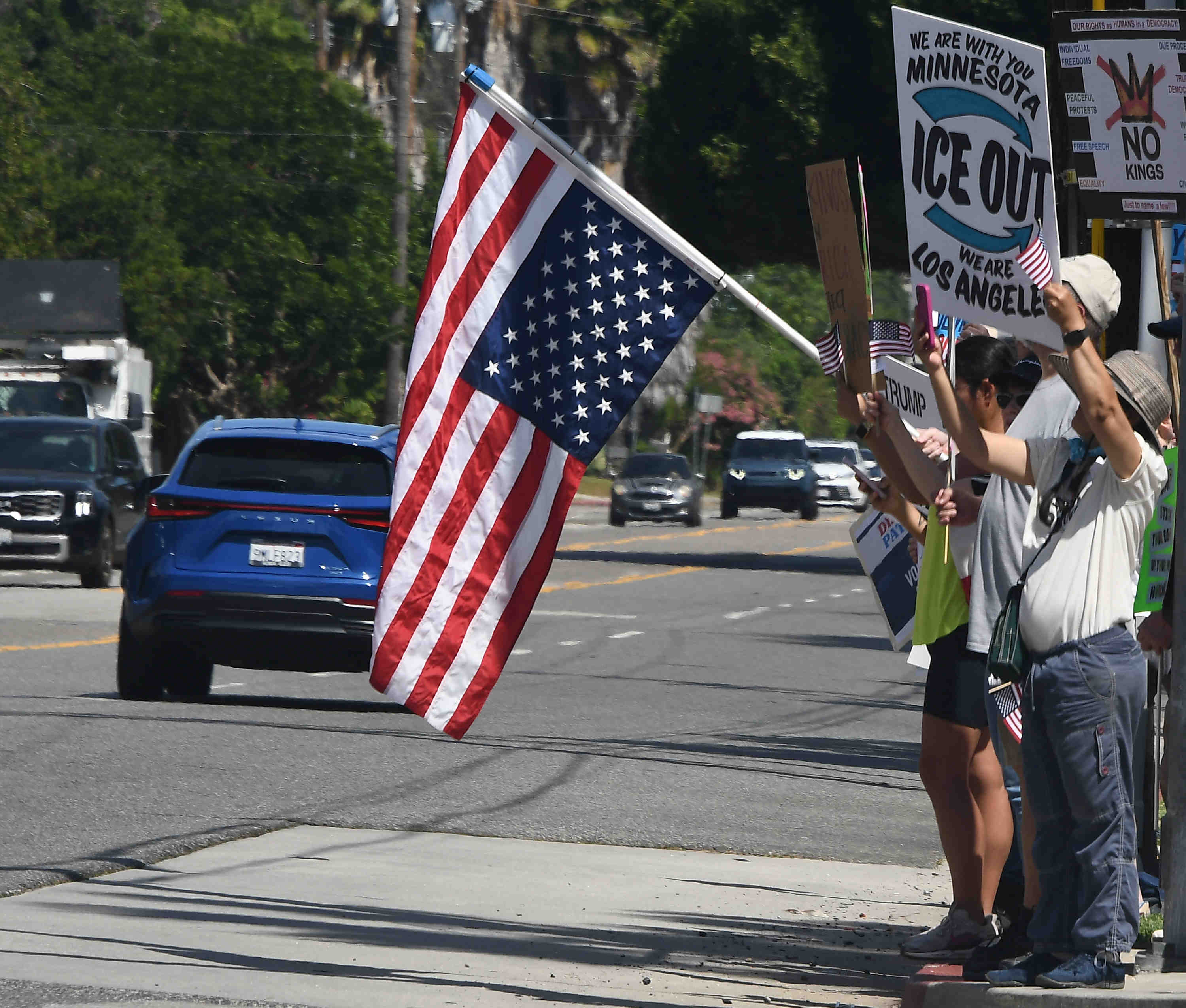 An American flag is flown upside down as an estimated...