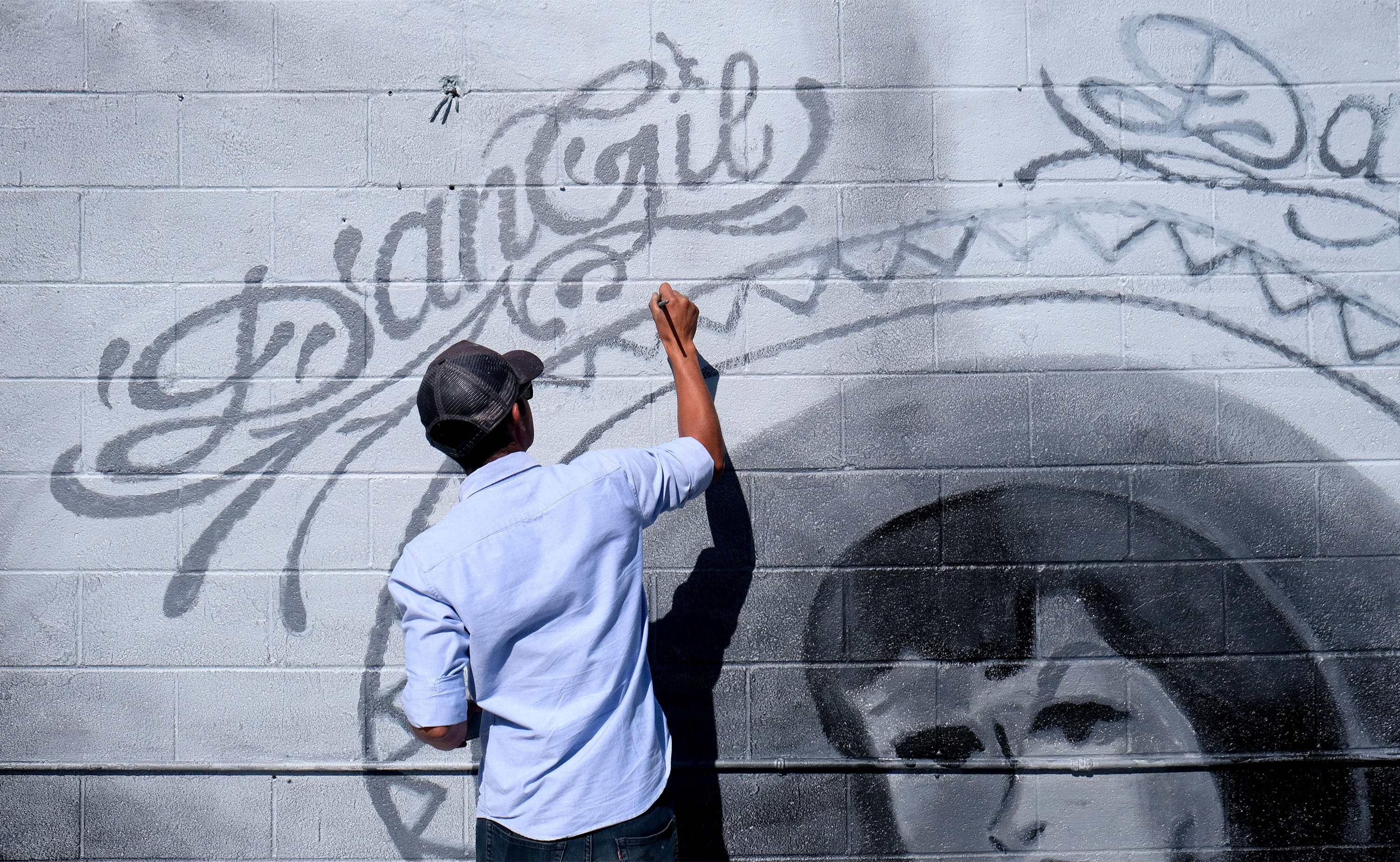 Muralist Levi Ponce works on restoring his iconic Danny Trejo...