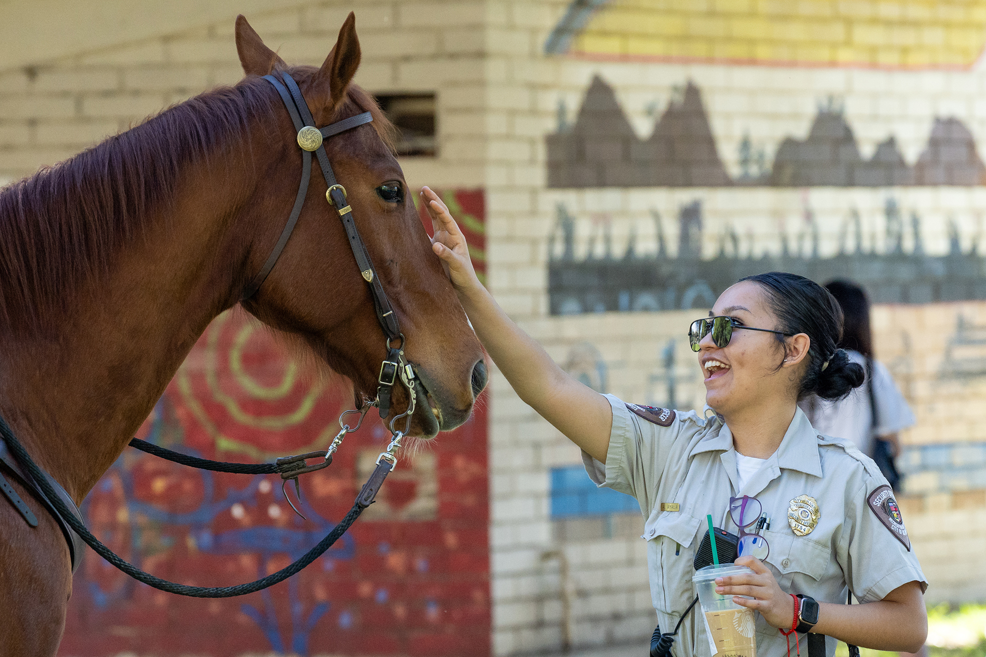 Los Angeles City Park Ranger Alexa Ayala greets a horse...