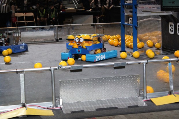 The La Jolla High Vikings' Minions-themed robot scoops up yellow balls called "fuel" to shoot into a bin called a "hub." (Jasmine Vaughan)