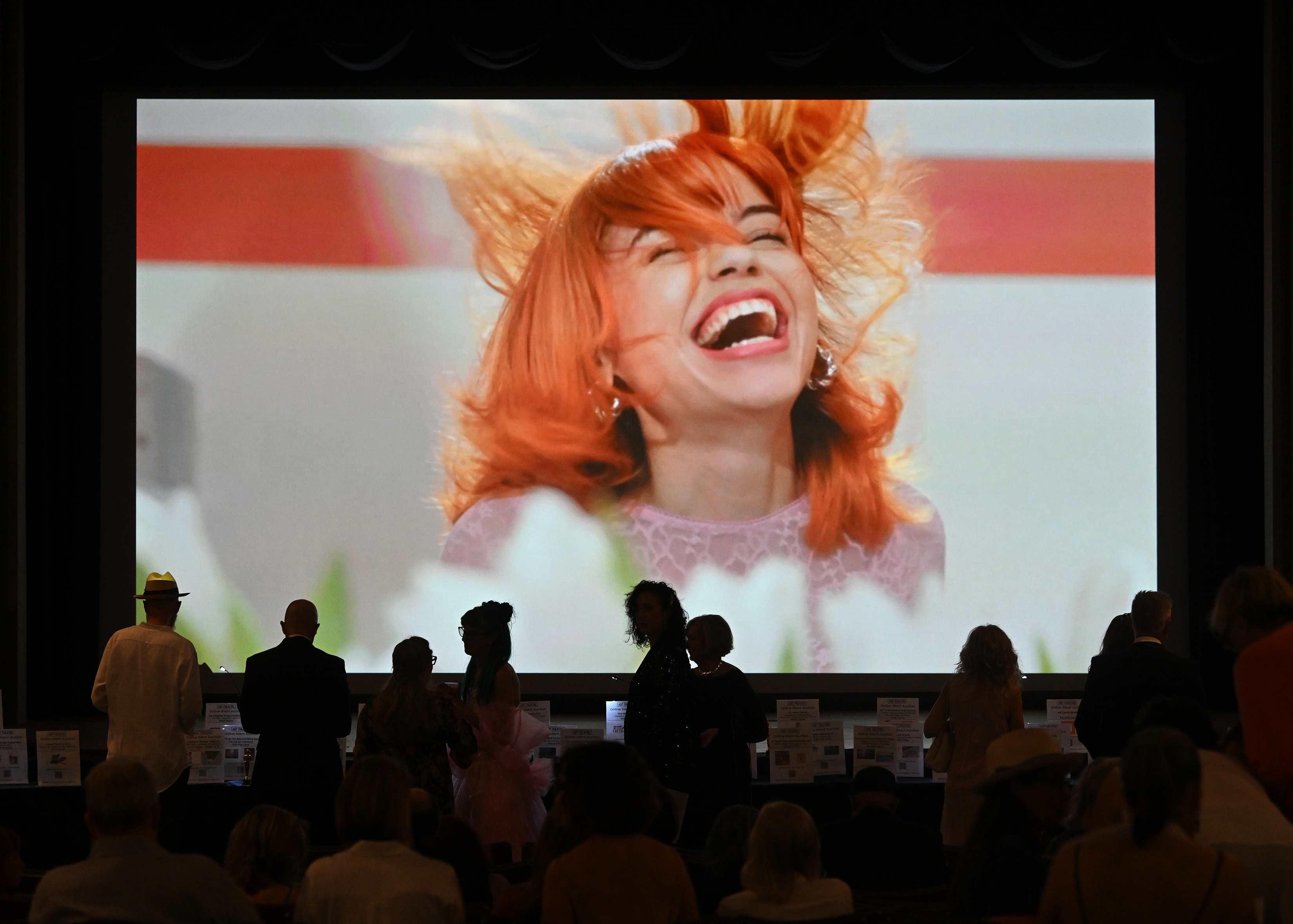 People participate in the silent auction during the Long Beach...