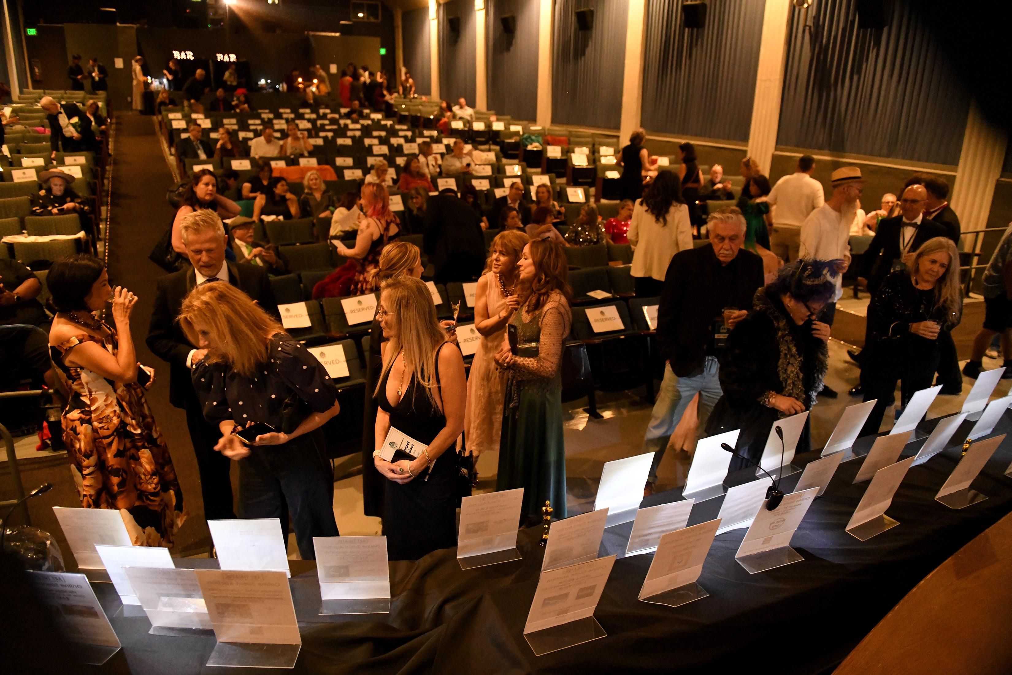 People participate in the silent auction during the Long Beach...
