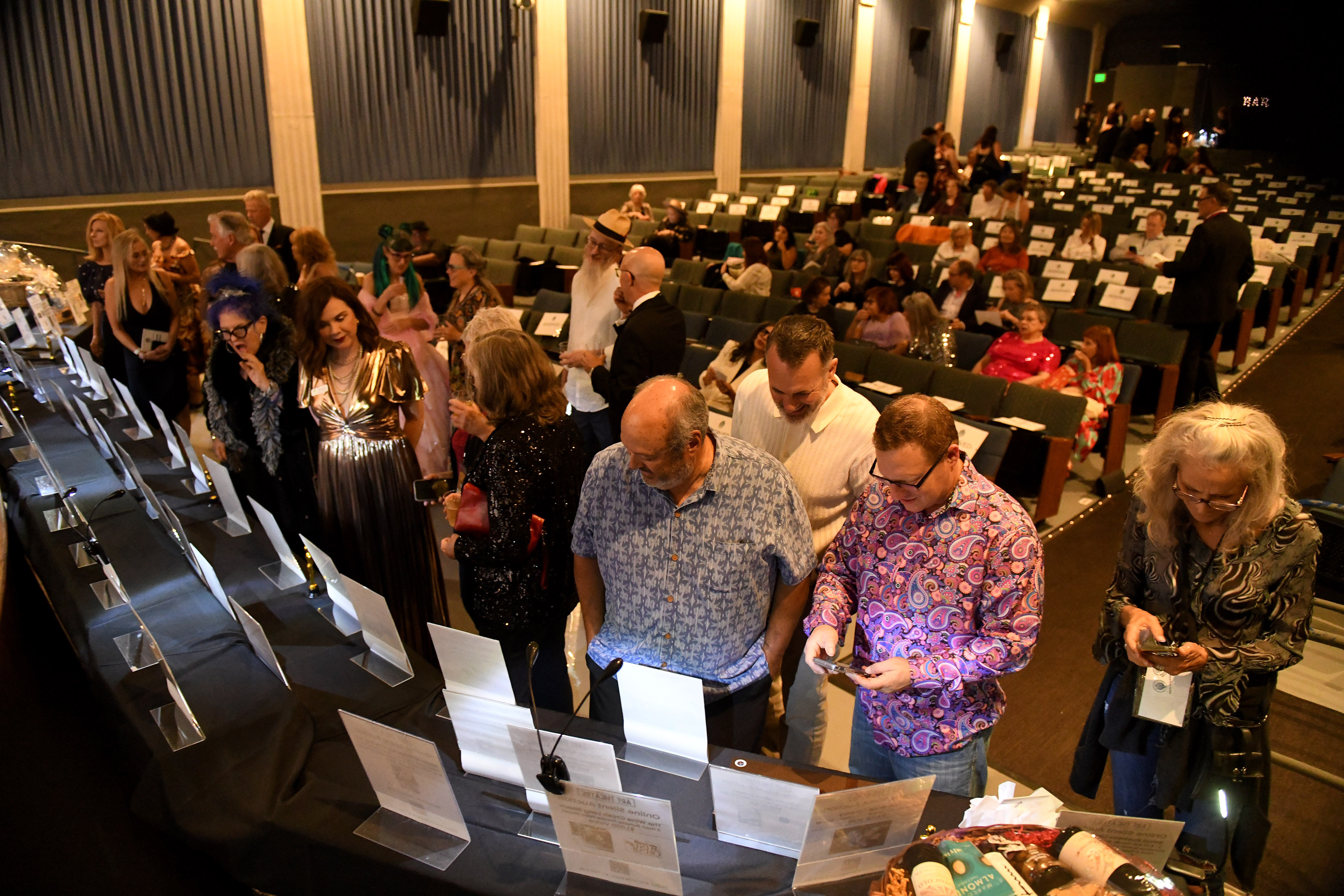 People participate in the silent auction during the Long Beach...