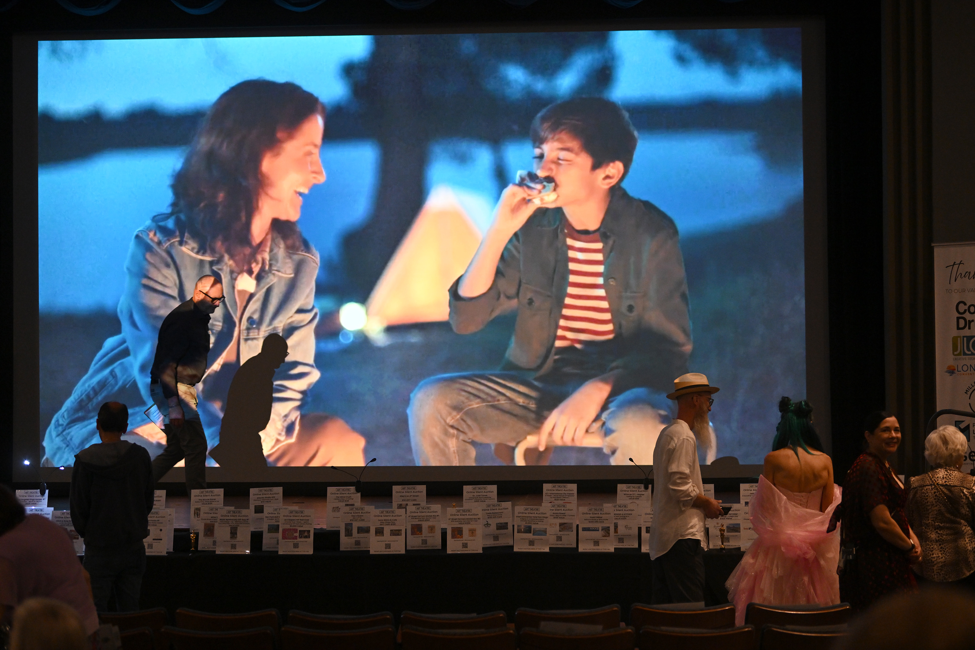 People participate in the silent auction during the Long Beach...