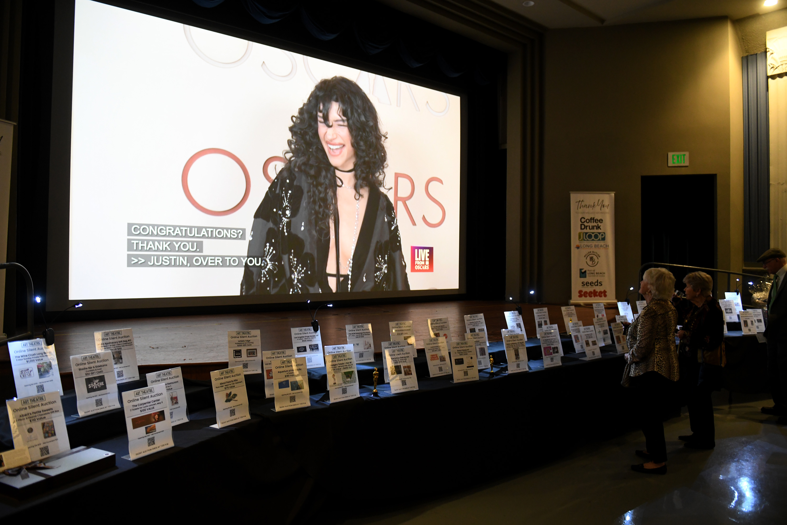 People participate in the silent auction during the Long Beach...