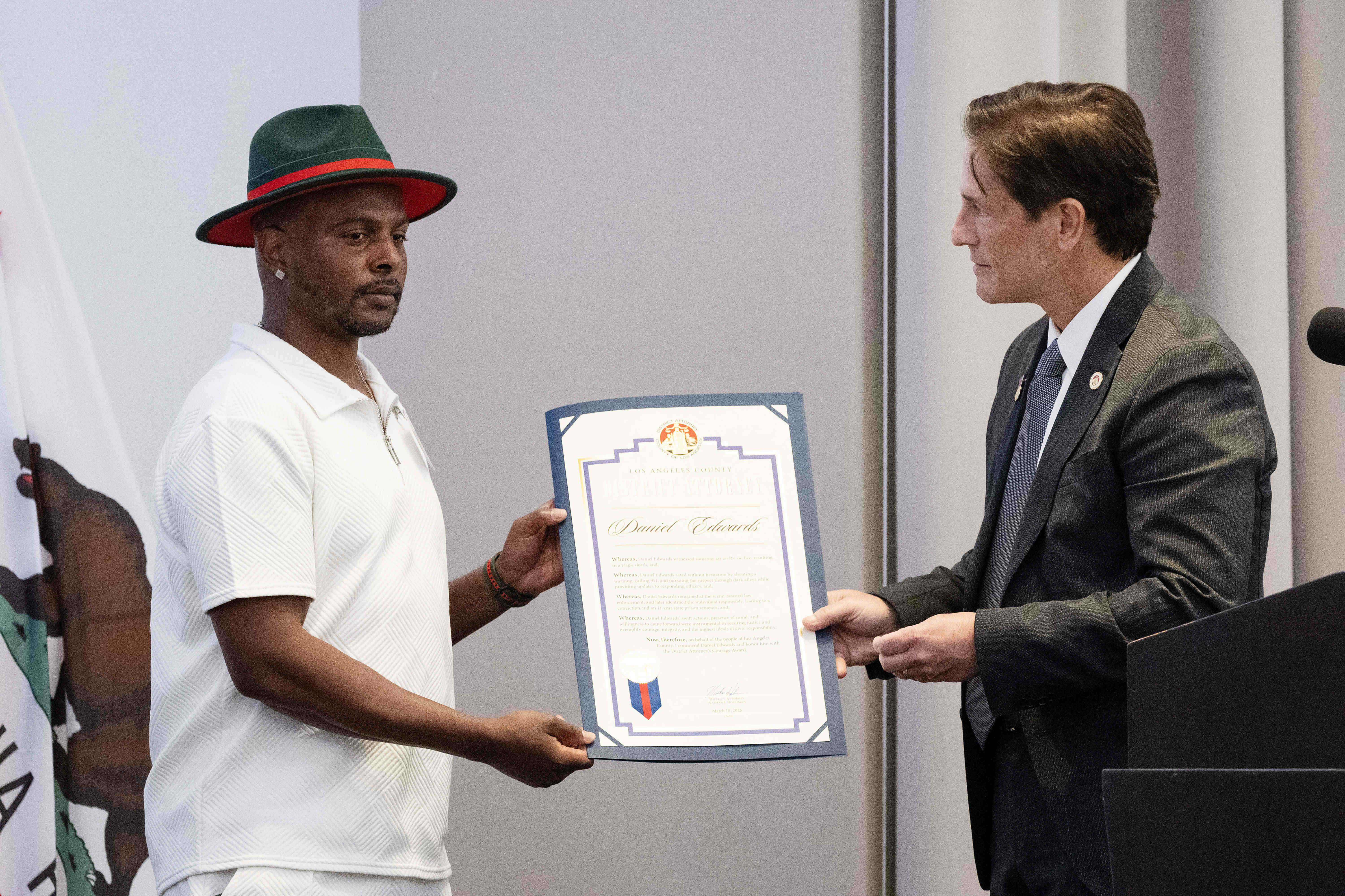 From right, LA County DA Nathan Hochman presents Daniel Edwards...
