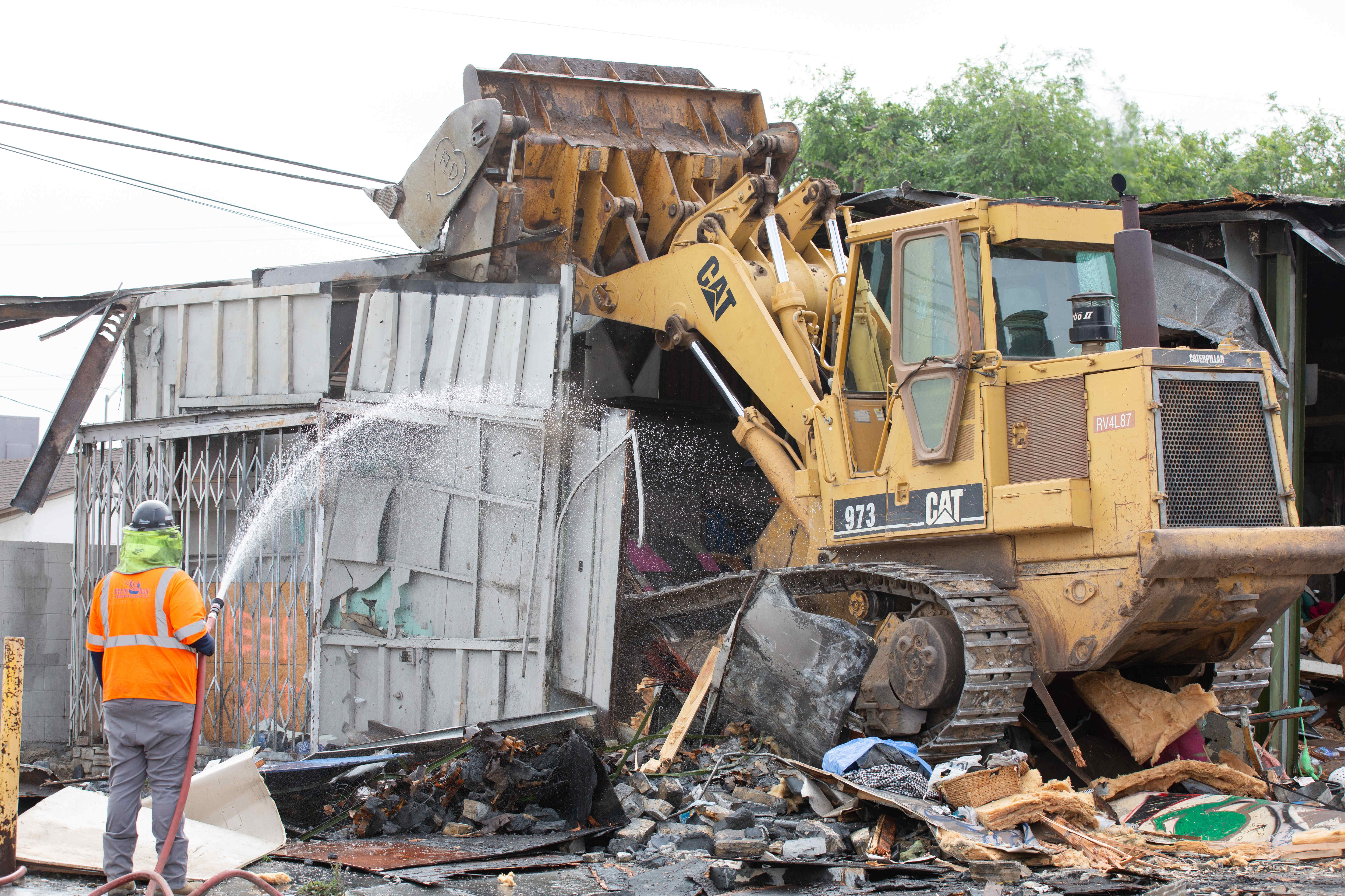 Work crews pull apart an abandoned gas station and fast...