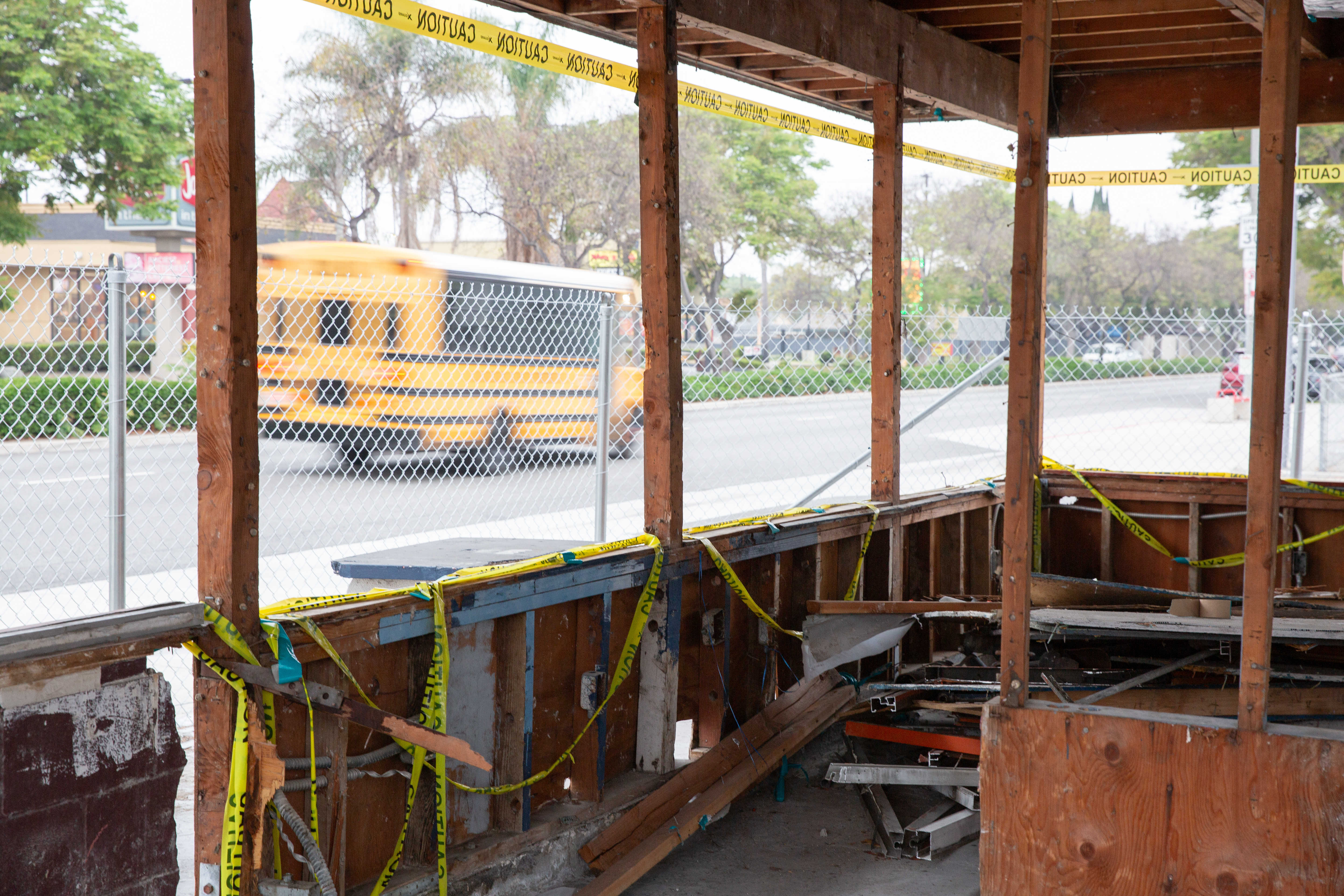 A school bus passes by an abandoned and gutted fast...