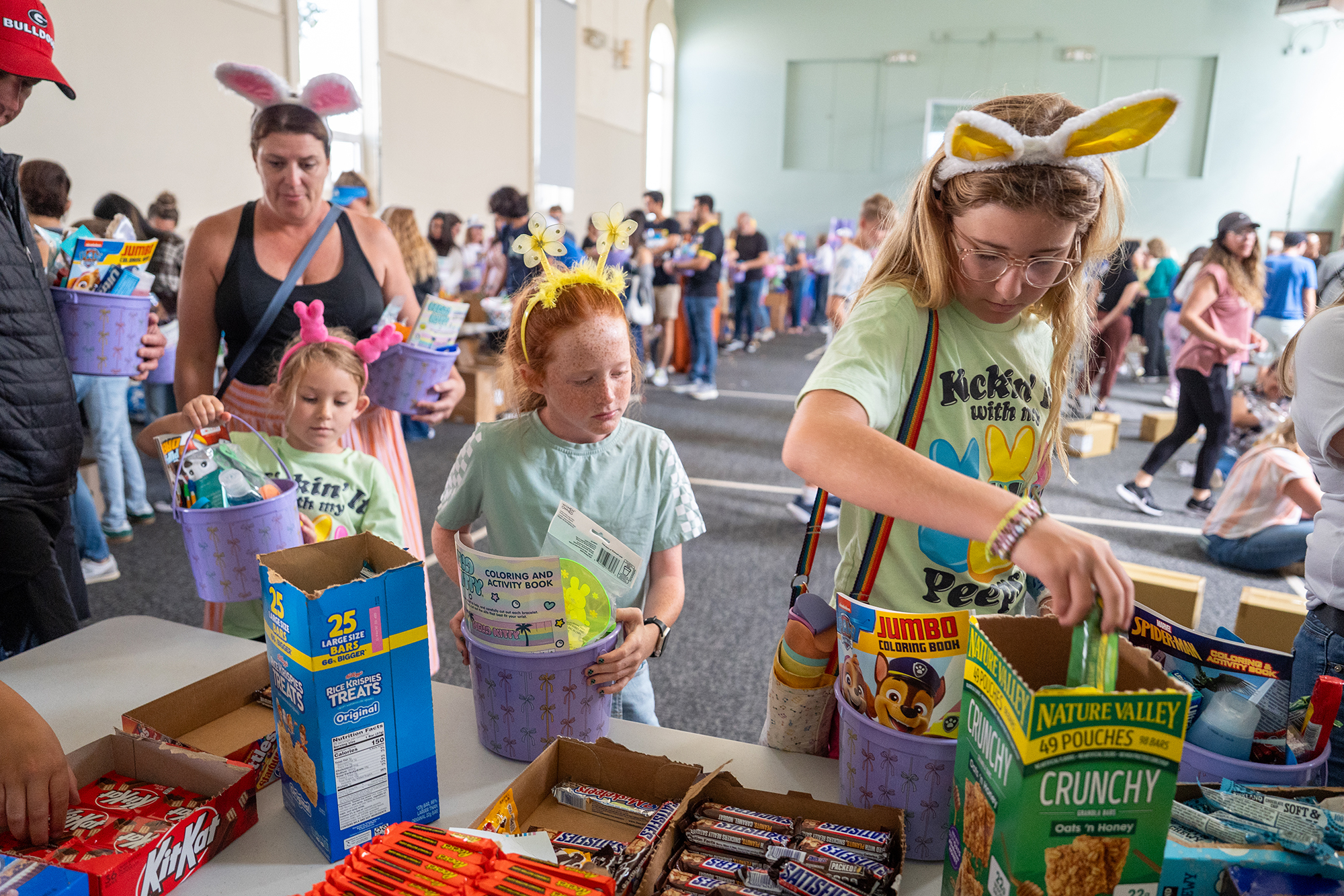 Members of the Johnson family and their children assemble treats...
