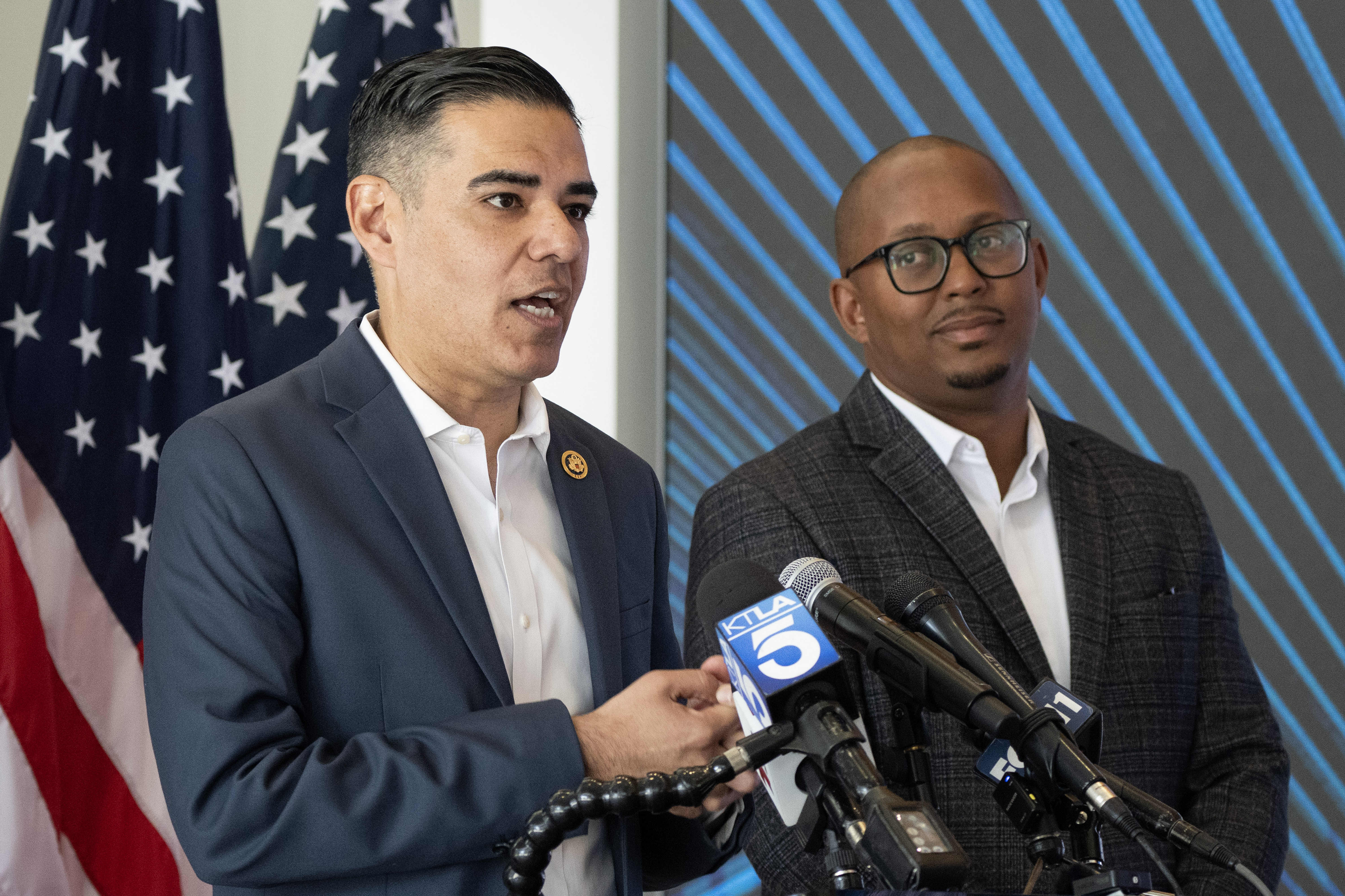 Congressman Robert Garcia, left, speaks during a press conference announcing...