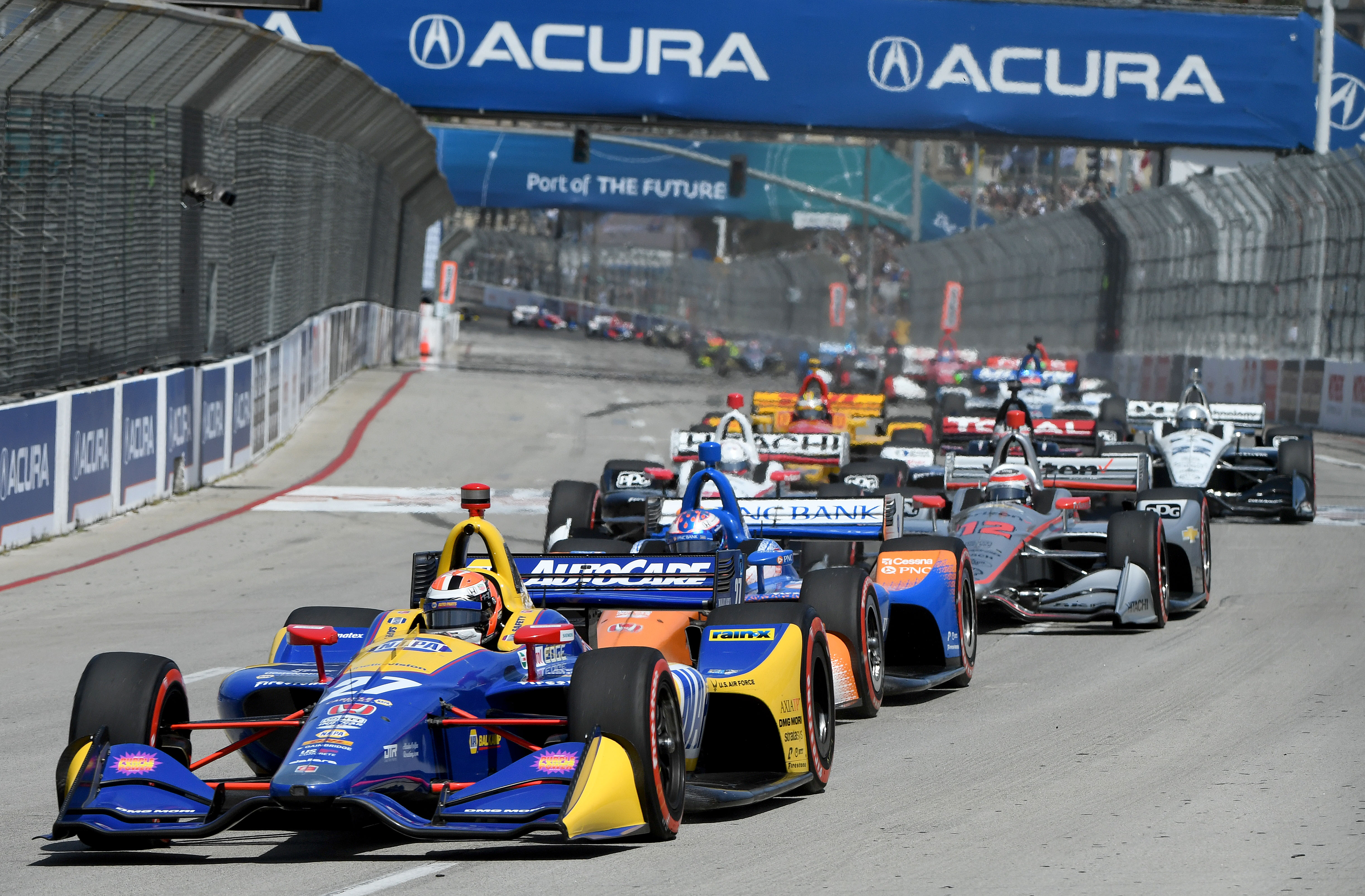 Alexander Rossi leads the field down Shoreline Drive to start...