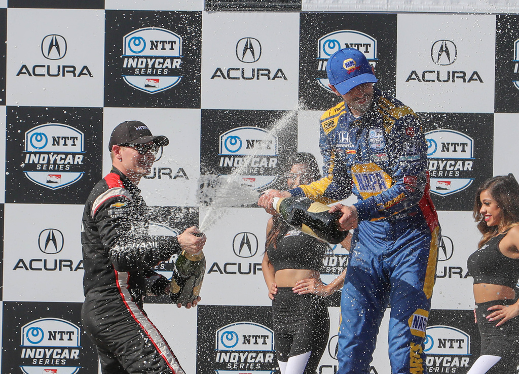 Alexander Rossi gets a champagne bath after winning the Acura...