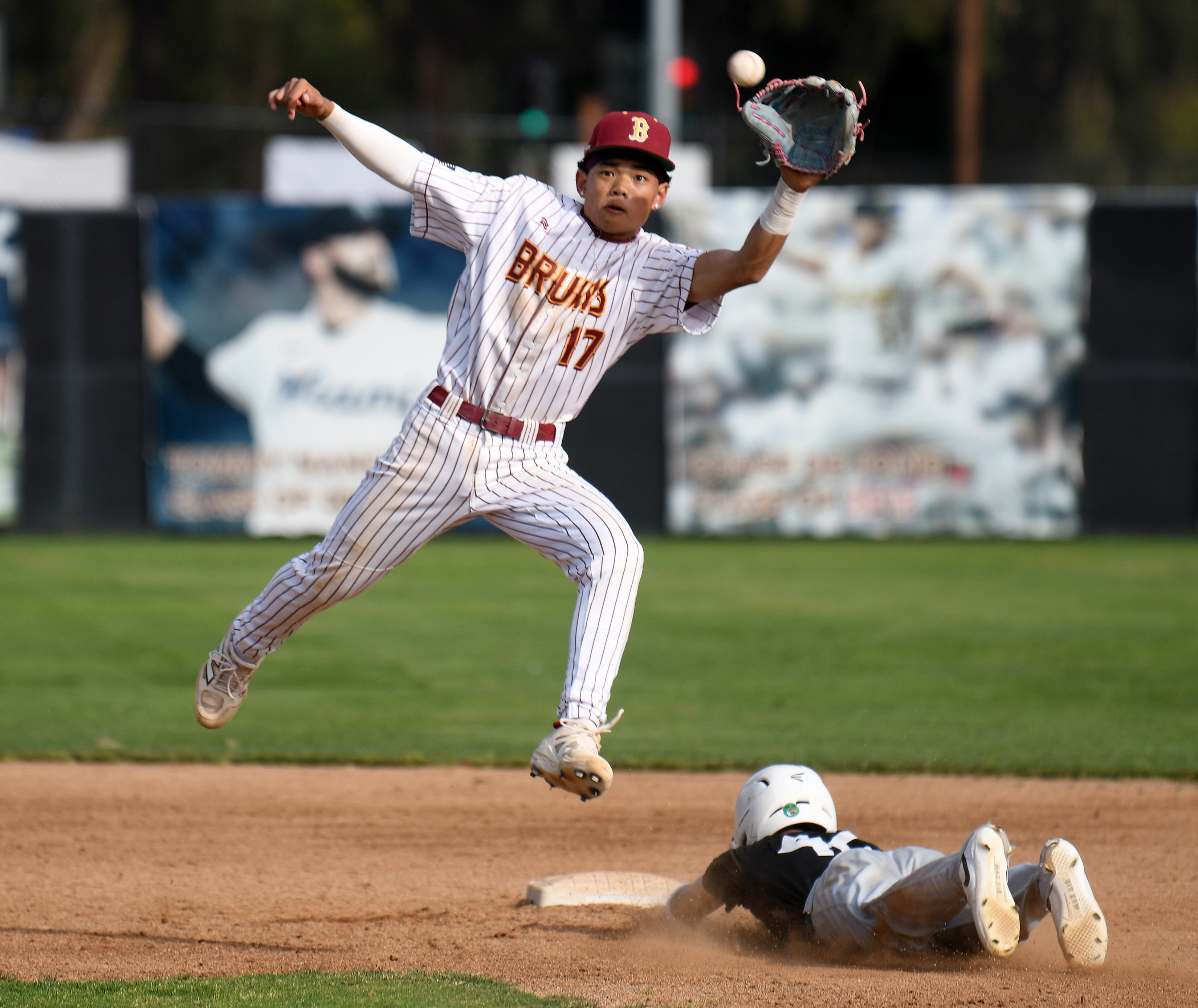 Nicholas Thiem has the catch for Wilson as Cabrillo baserunner...
