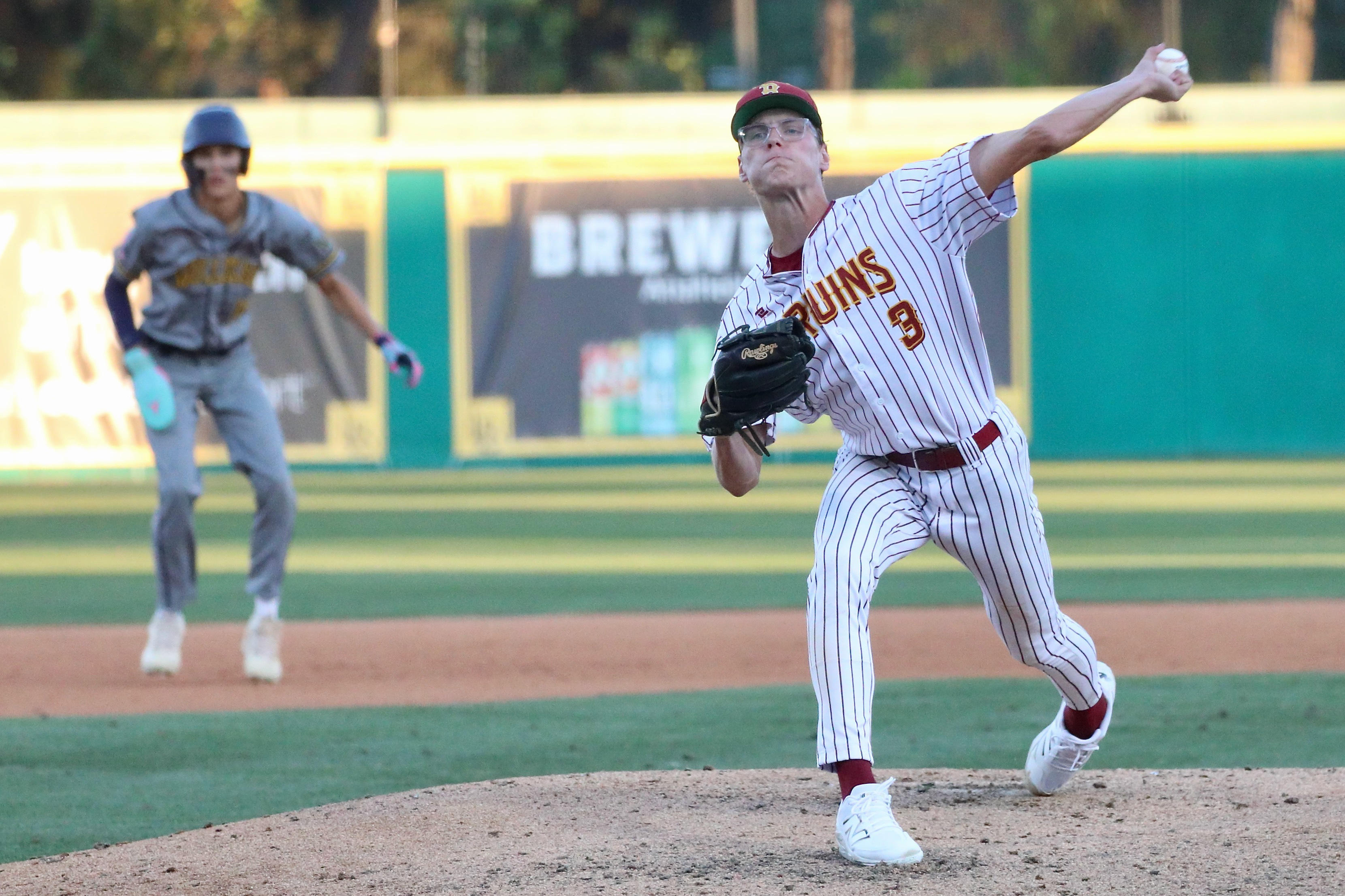Wilson starter George Cooper delivers a pitch en route to...
