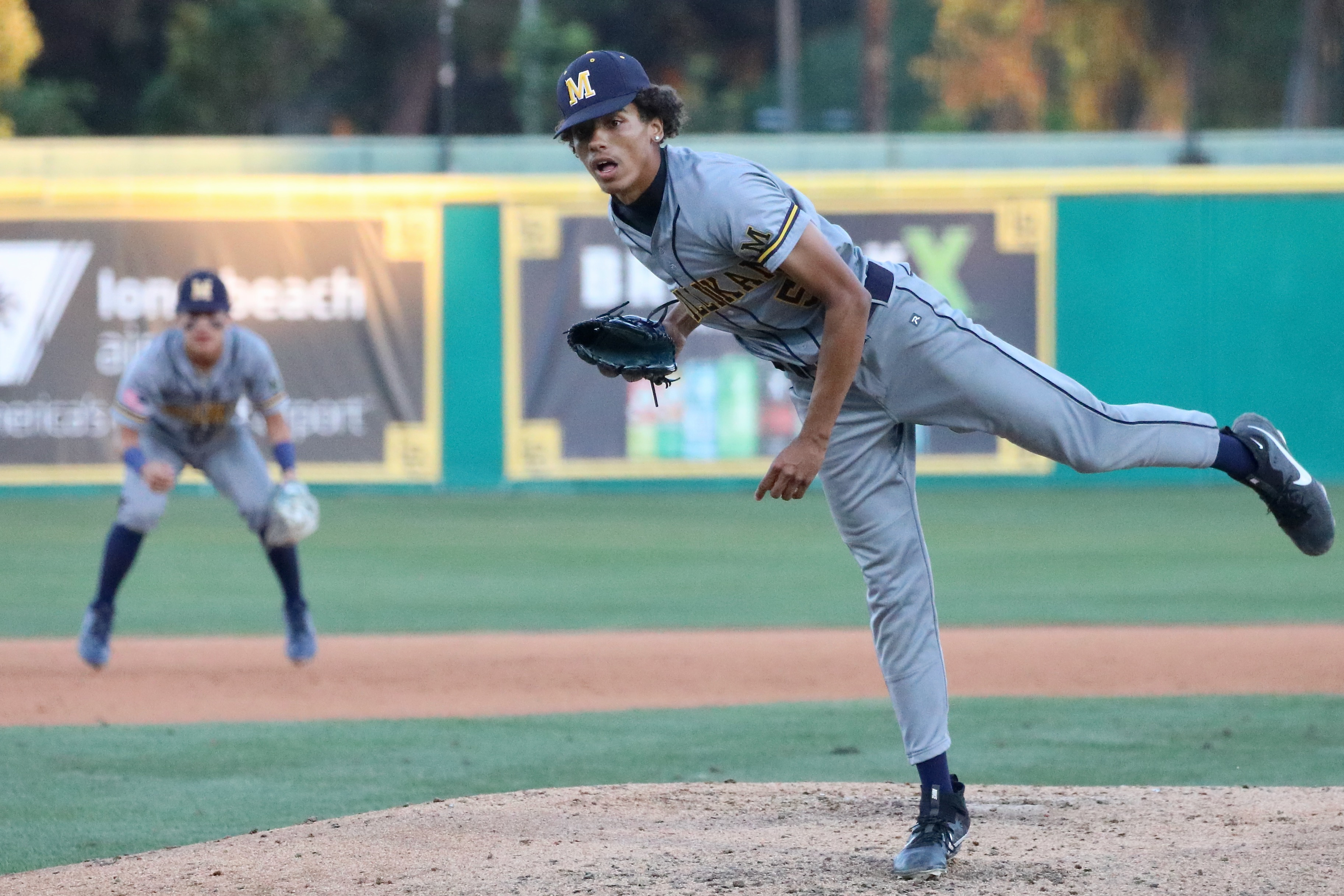 Millikan starter Duante Bell follows through on a pitch with...