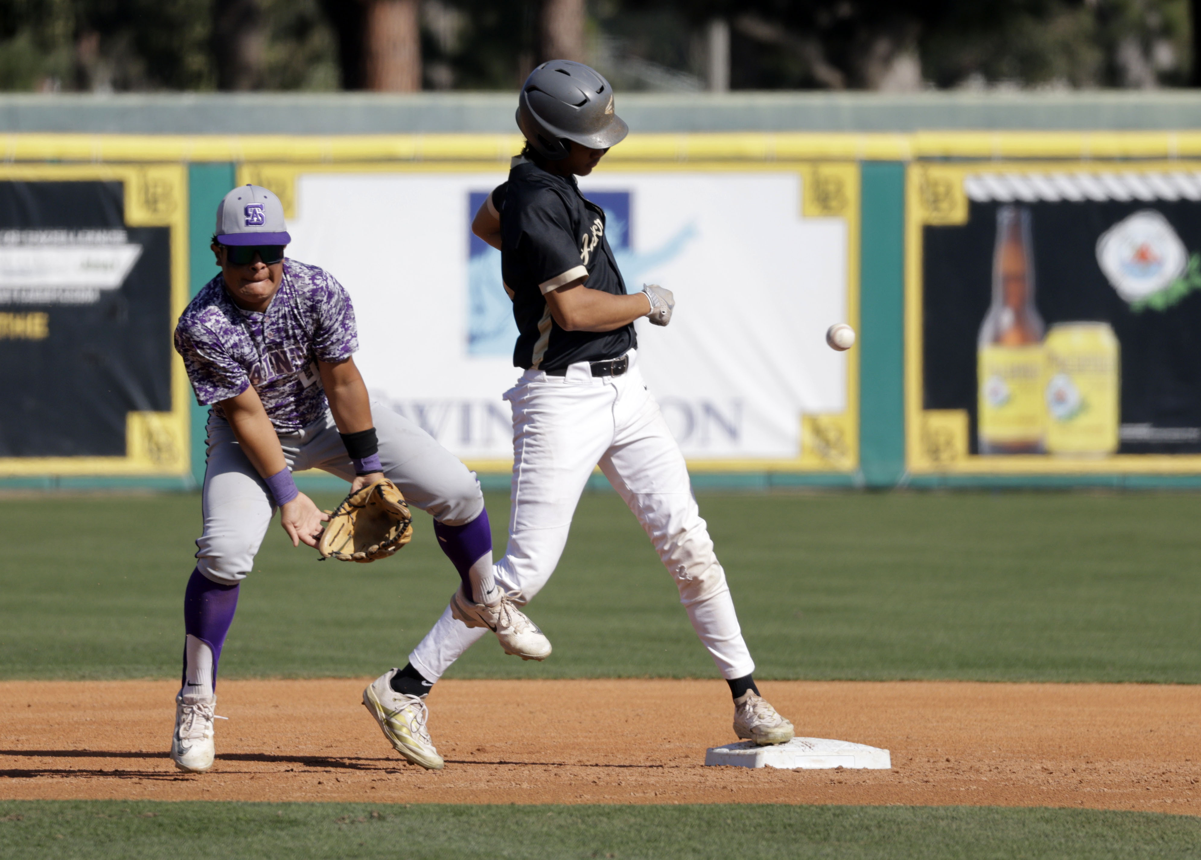 Long Beach Poly’s Neil Morris (40) is safe as the...