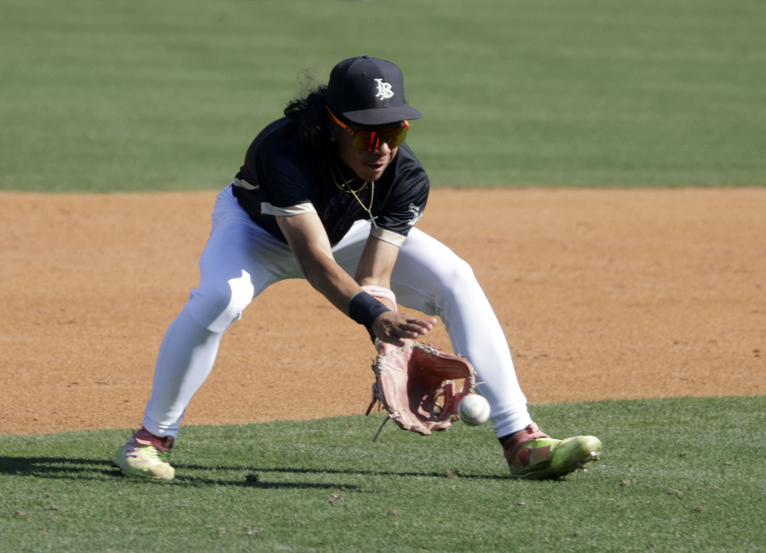 Long Beach Poly’s Malakai Pruitt (2) gets in front of...