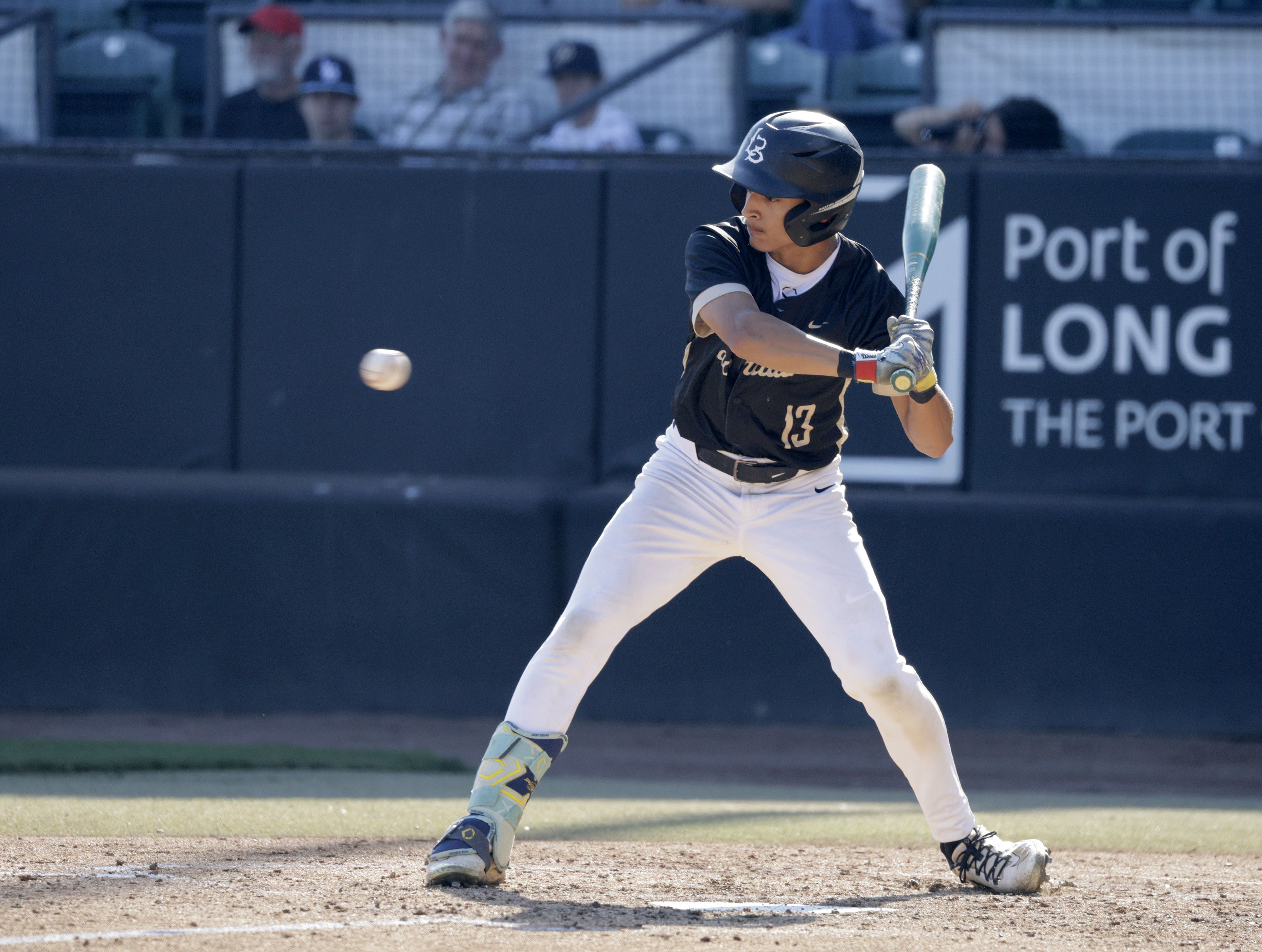 Long Beach Poly’s Fausto Gaxiola III (13) waits for the...