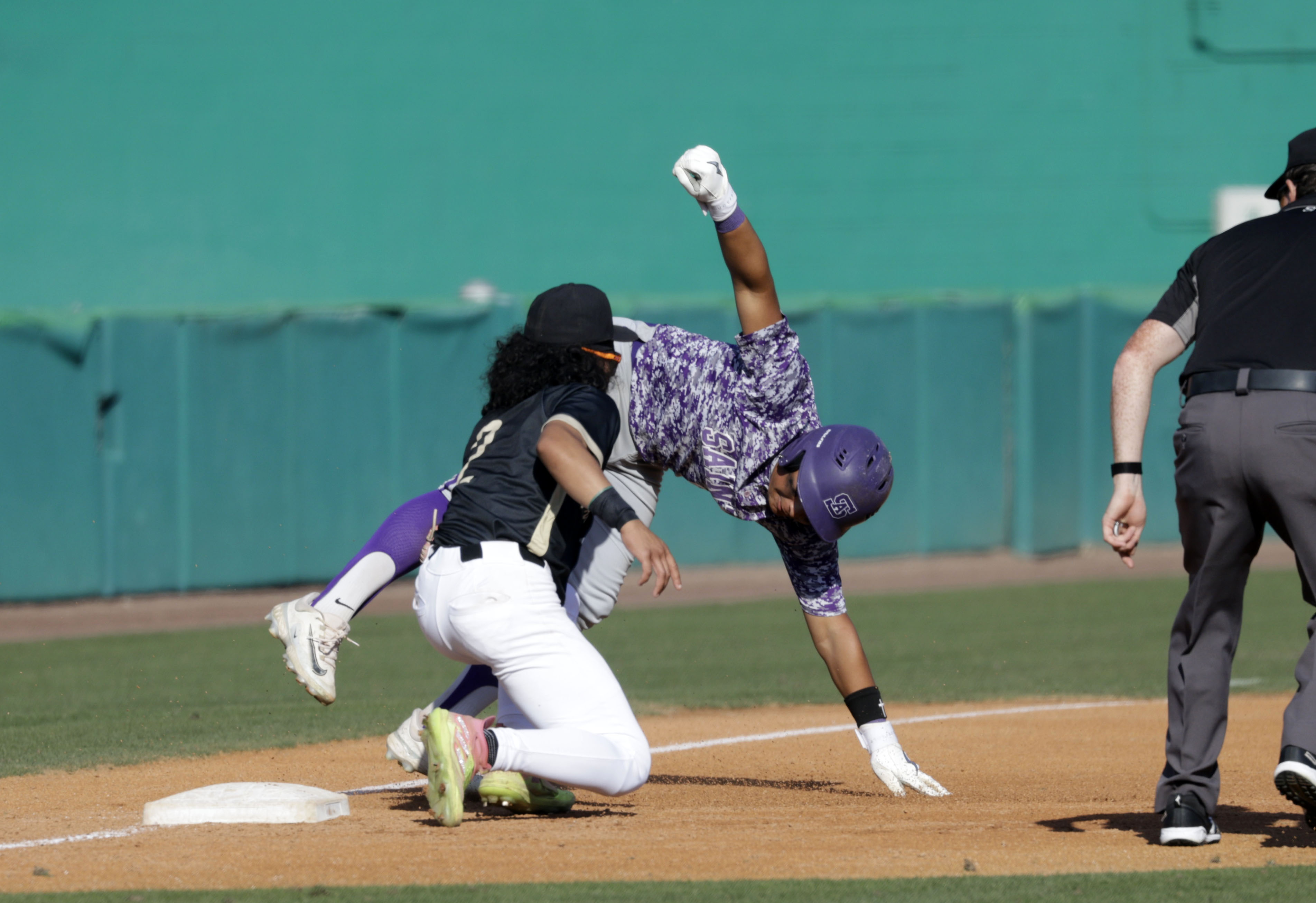 Long Beach Poly’s Malakai Pruitt (2) tags out St. Anthonys...
