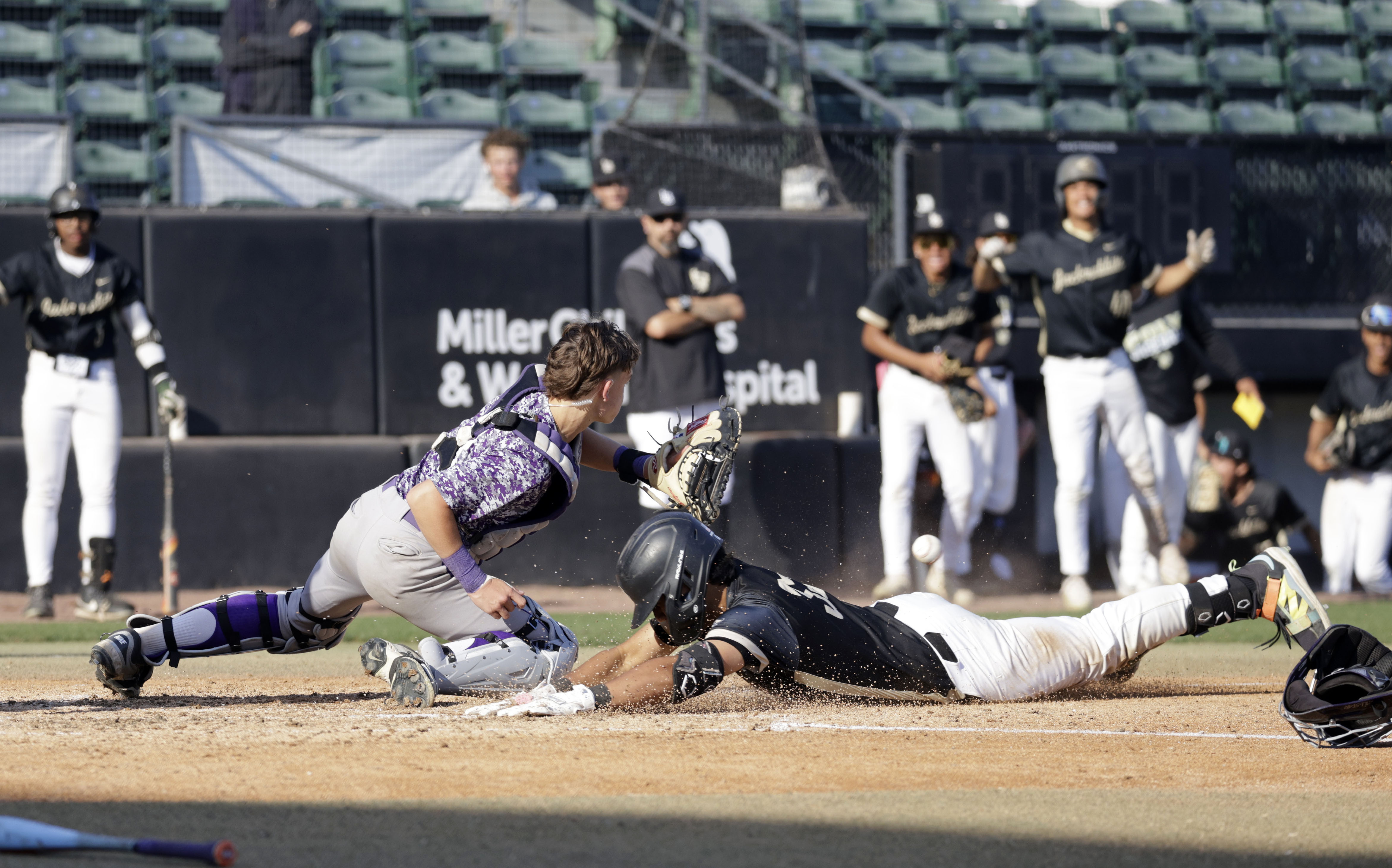 Long Beach Poly’s Caleb Safotu (35) slides into home as...