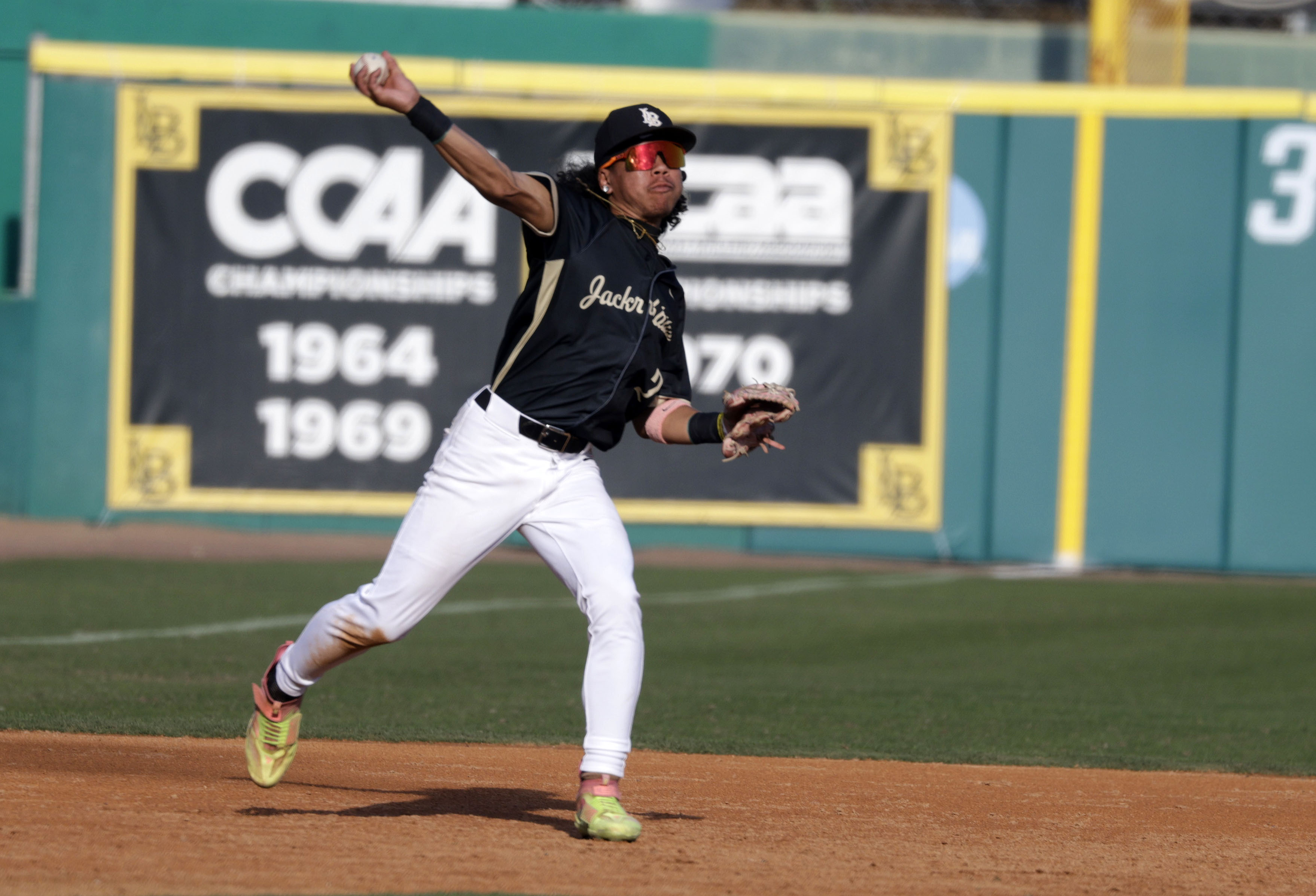 Long Beach Poly’s Malakai Pruitt (2) throws to first as...