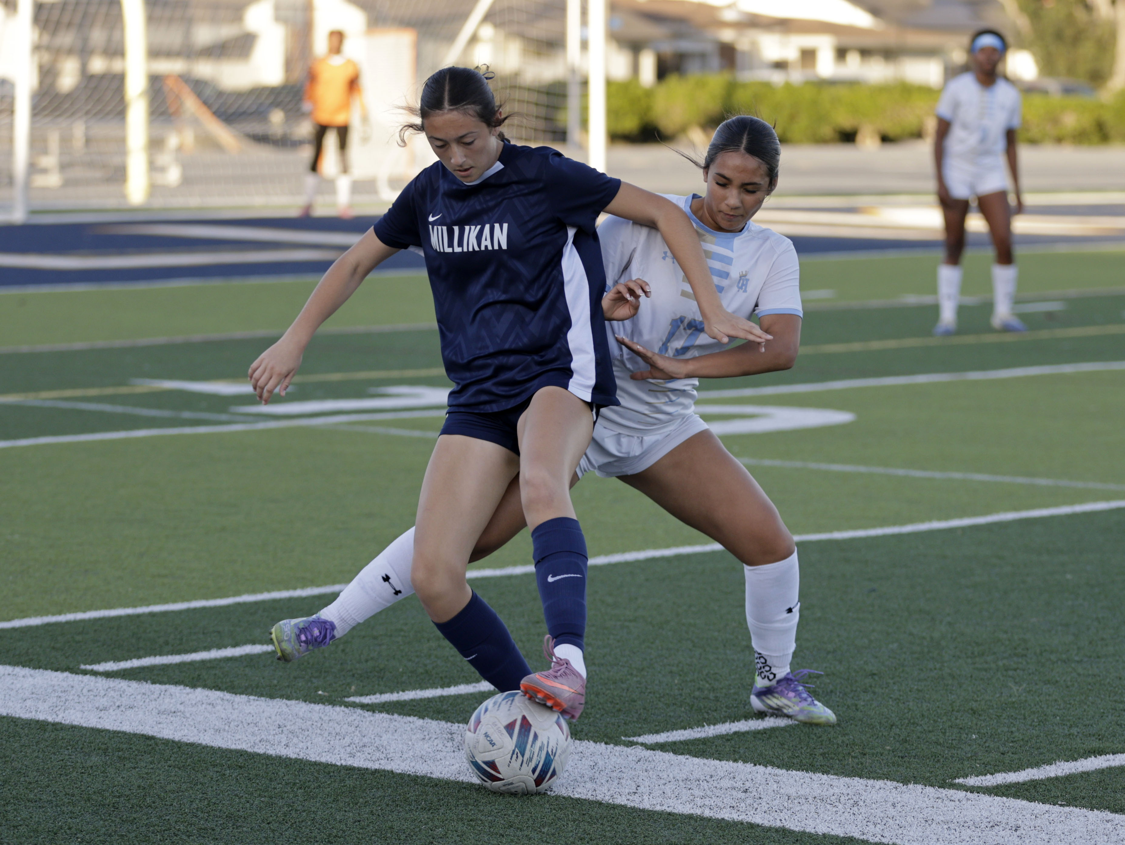Millikans Ava Parkhill (21) tries to keep the ball from...