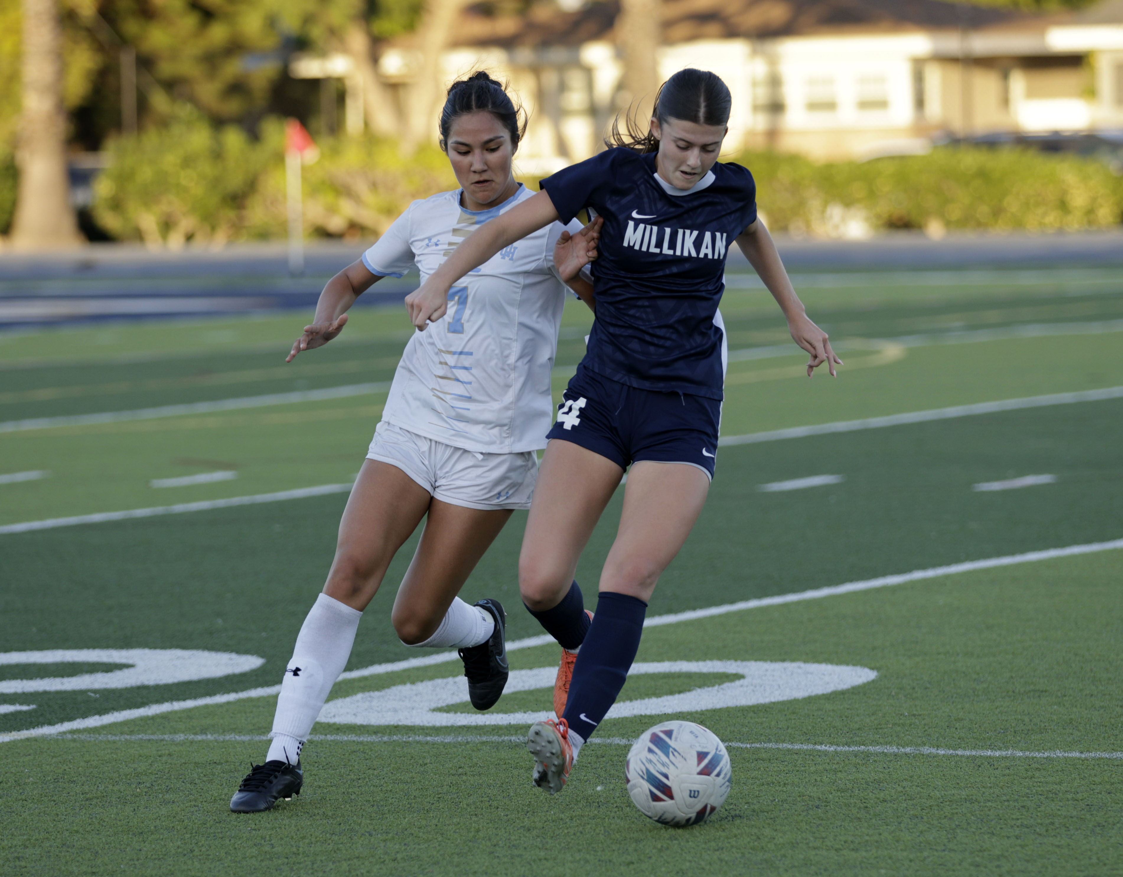 Millikans Caoimhe Tighe (14) tries to keep the ball from...
