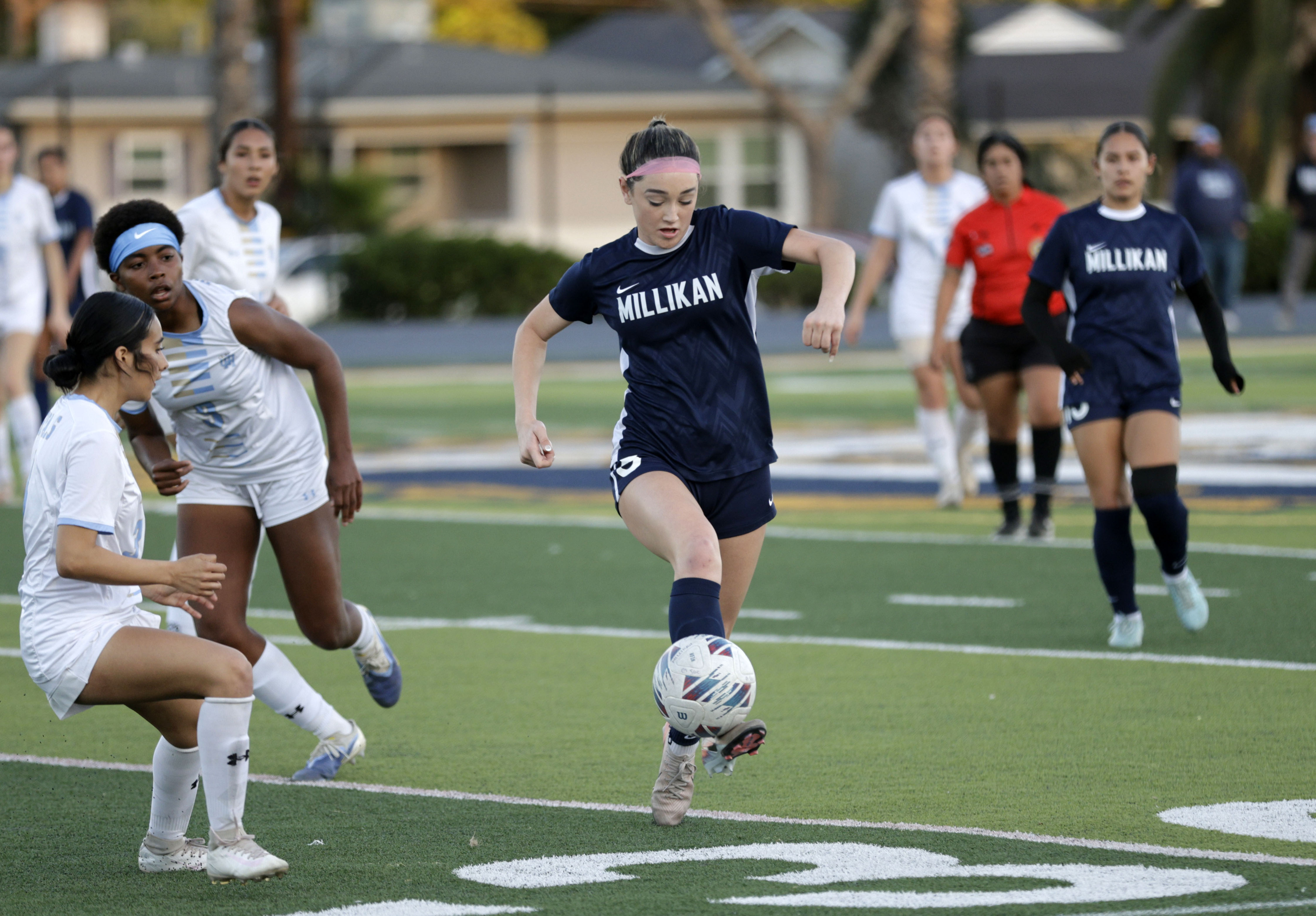 Millikans Adeline Murphy (8) kicks the ball away from Quartz...