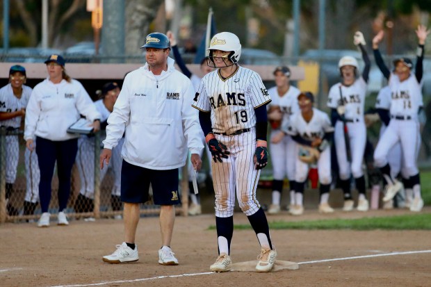 Millikan's Addy Everrett smiles at third base after hitting a first inning RBI triple against Lakewood on Friday, Mar. 21, 2025, in Moore League softball action at Mayfair Park in Lakewood. (Photo by Howard Freshman, Contributing Photographer)