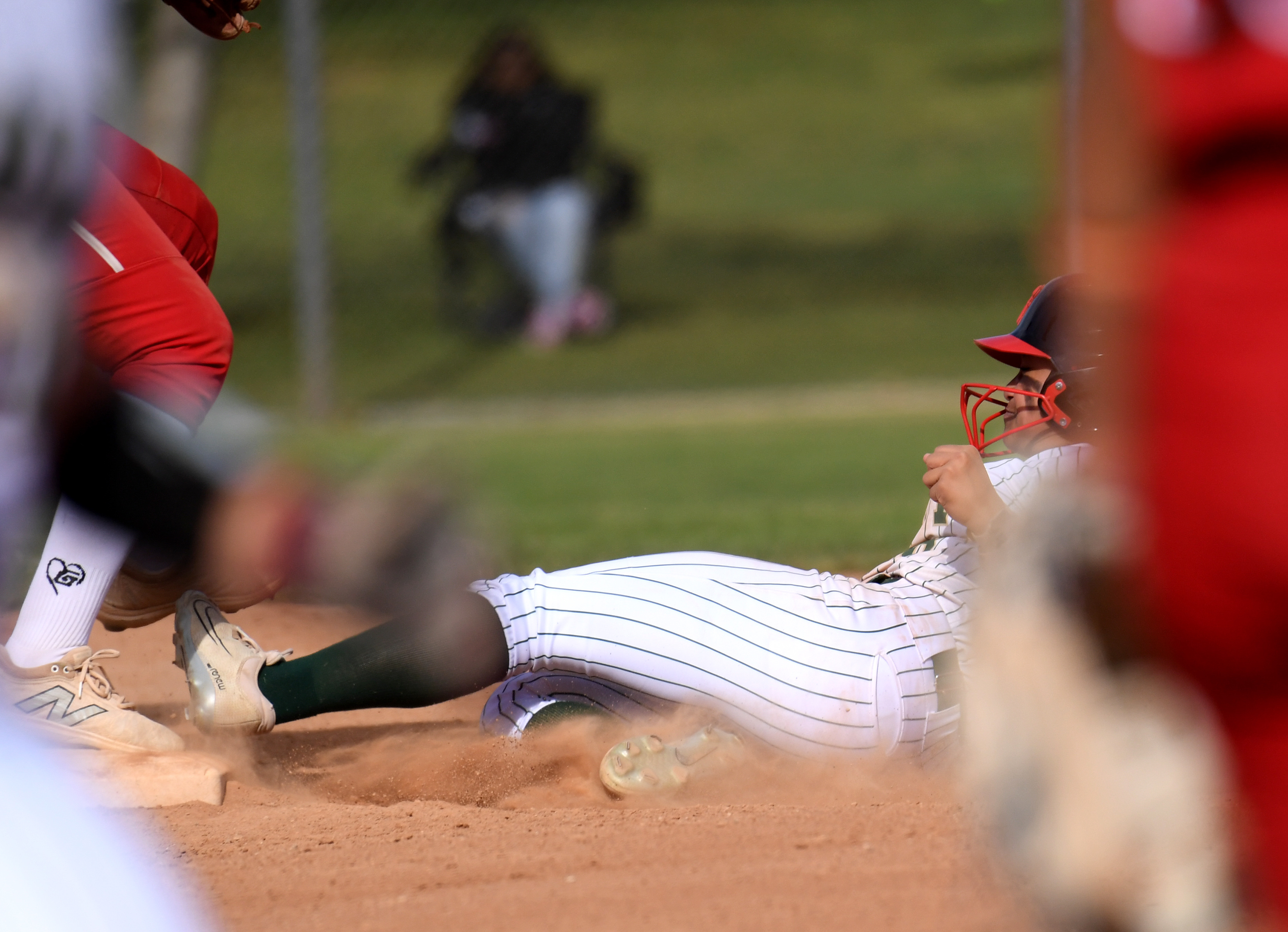 Long Beach Poly’s Persjah Lam Sam slides into second base...