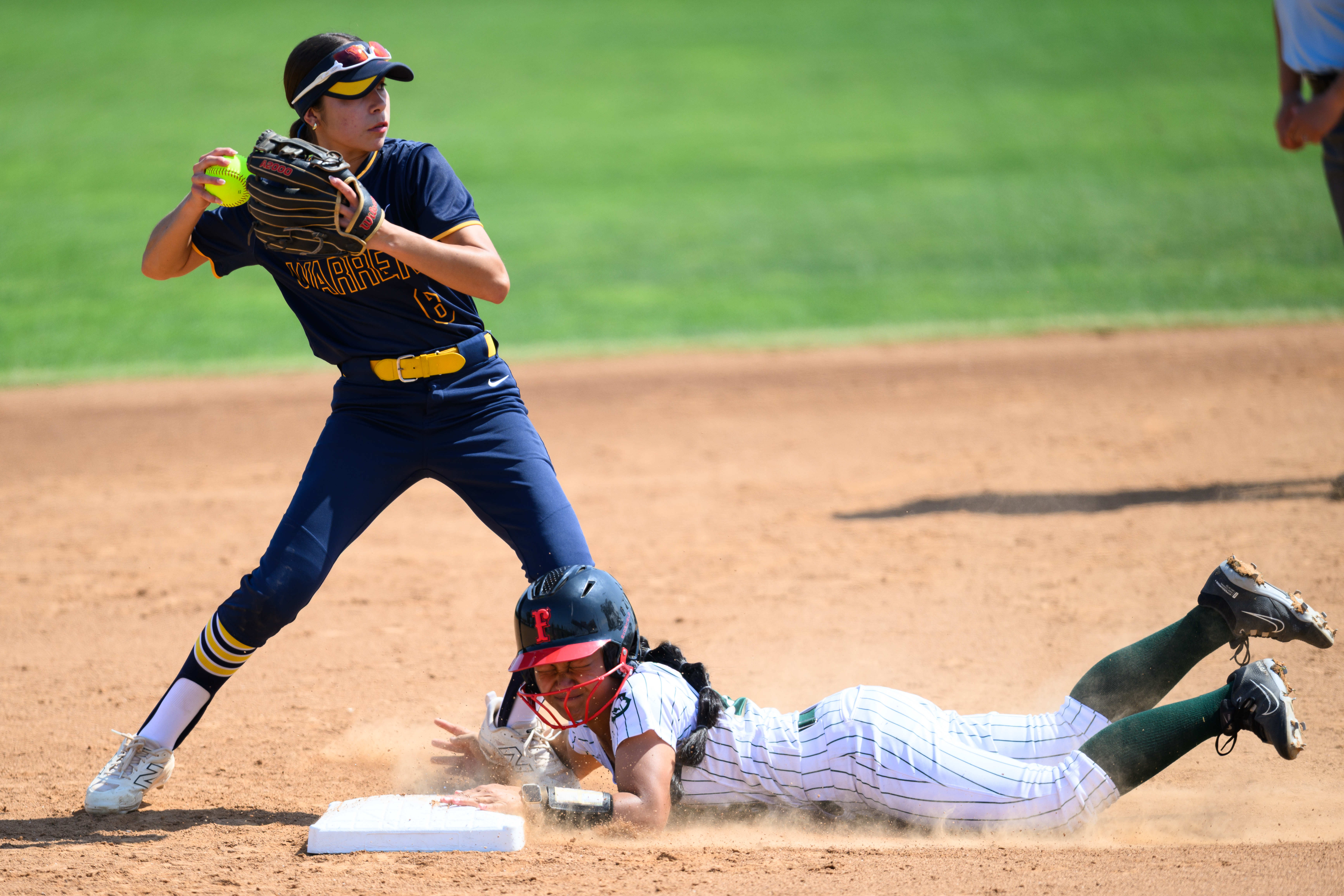 Long Beach Poly’s Persjah Lam Sam, right, is forced out...